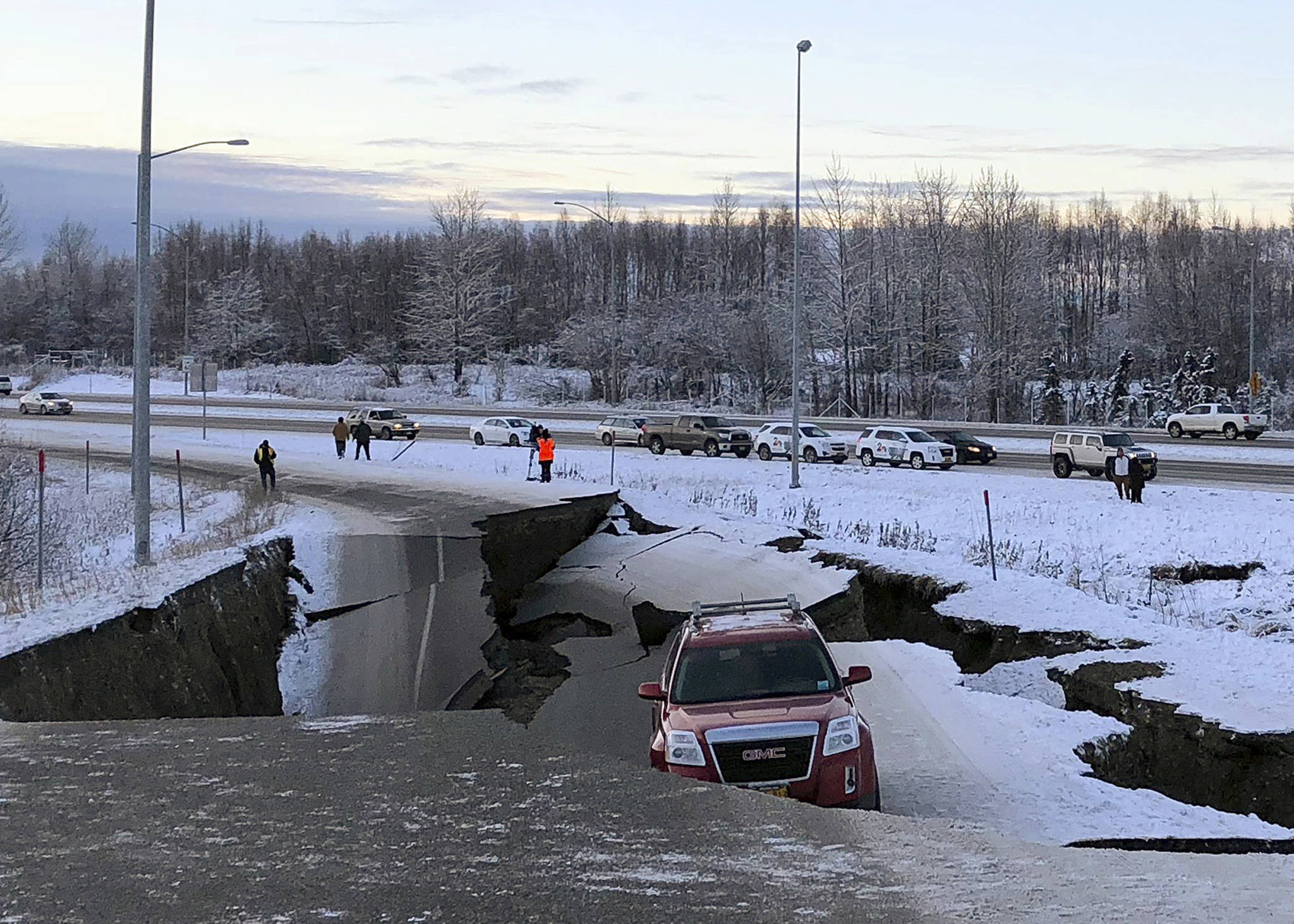 A car is trapped on a collapsed section of the offramp of Minnesota Drive in Anchorage, Friday, Nov. 30, 2018. Back-to-back earthquakes measuring 7.0 and 5.8 rocked buildings and buckled roads Friday morning in Anchorage, prompting people to run from their offices or seek shelter under office desks, while a tsunami warning had some seeking higher ground. (Dan Joling | Associated Press)