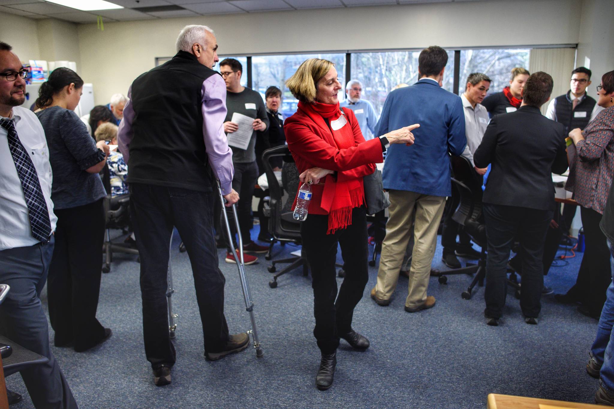 House District 1 Republican candidate Bart LeBon (on crutches) and Democratic candidate Kathryn Dodge (red jacket) watch ballots get counted at the Department of Elections on Friday, Nov. 30, 2018. (Michael Penn | Juneau Empire)