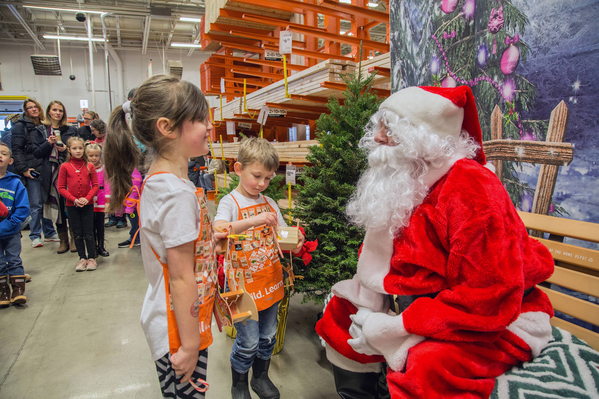 Children talk to Santa Claus at Home Depot in Juneau after he flew in for a visit on a Coastal Helicopter. (Courtesy Photo | Heather Holt)