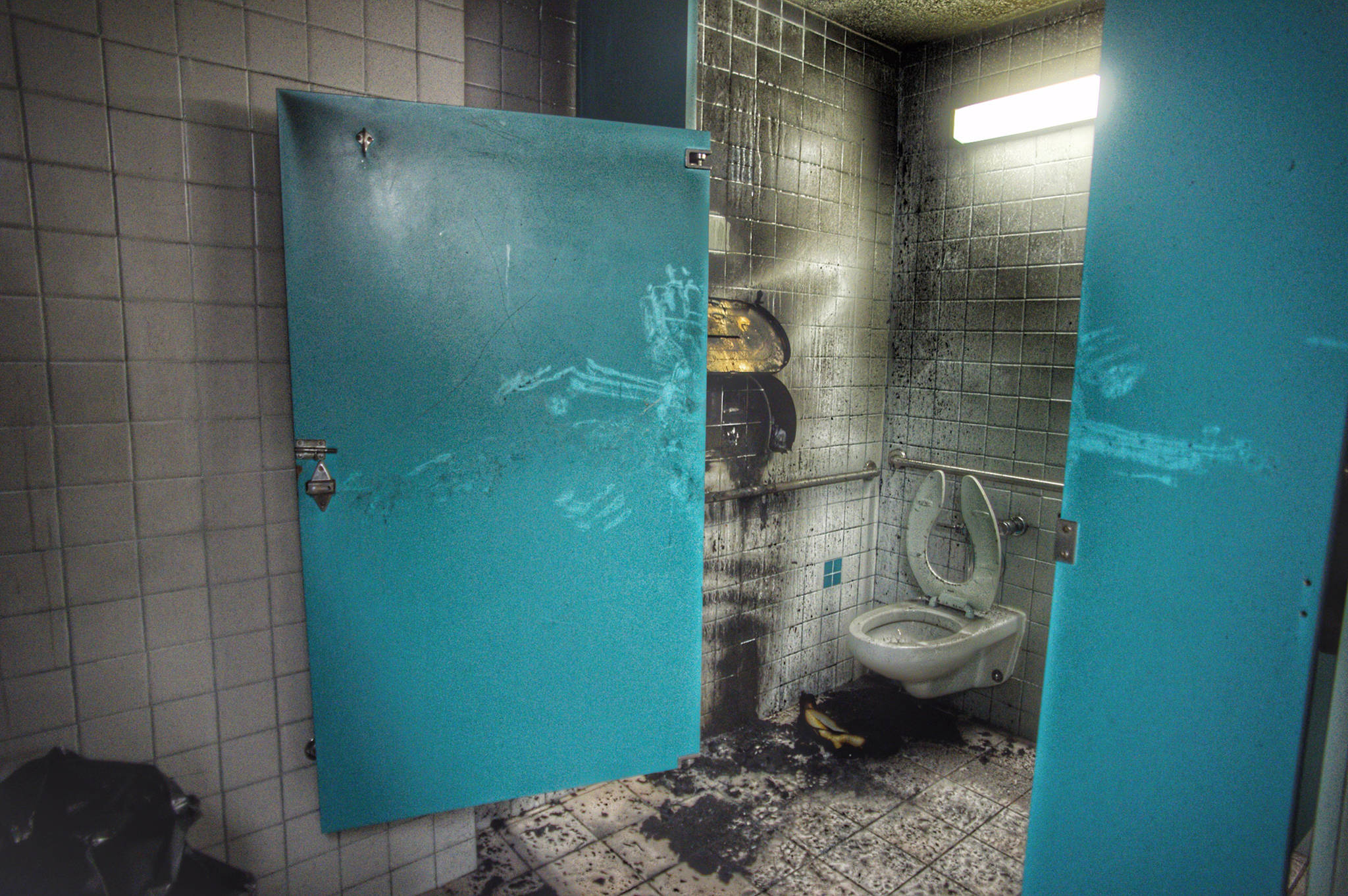 Smoke and fire damage in the men’s bathroom at the Mendenhall Mall on Wednesday, Dec. 5, 2018. (Michael Penn | Juneau Empire)