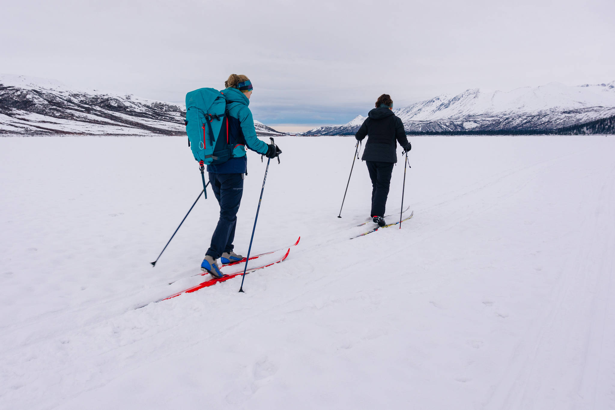 Katie and Claire cross country skiing across frozen Fielding Lake. (Gabe Donohoe | For the Juneau Empire)