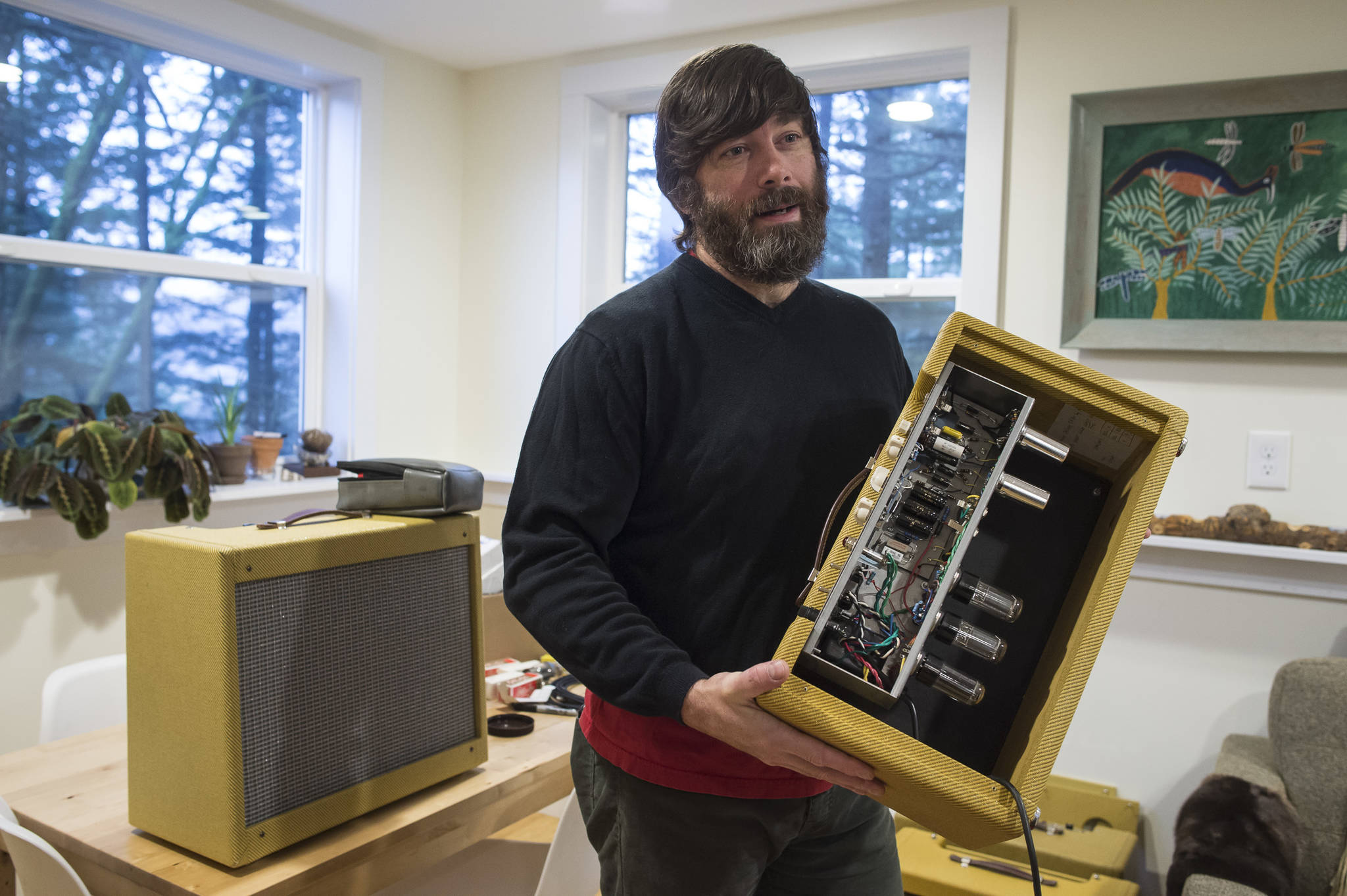 Reber Stein talks Wednesday, Dec. 5, 2018, about making tube amplifiers for his friends. Stein has been tinkering with the guitar amplifiers that make use of vacuum tubes for about a decade. (Michael Penn | Juneau Empire)