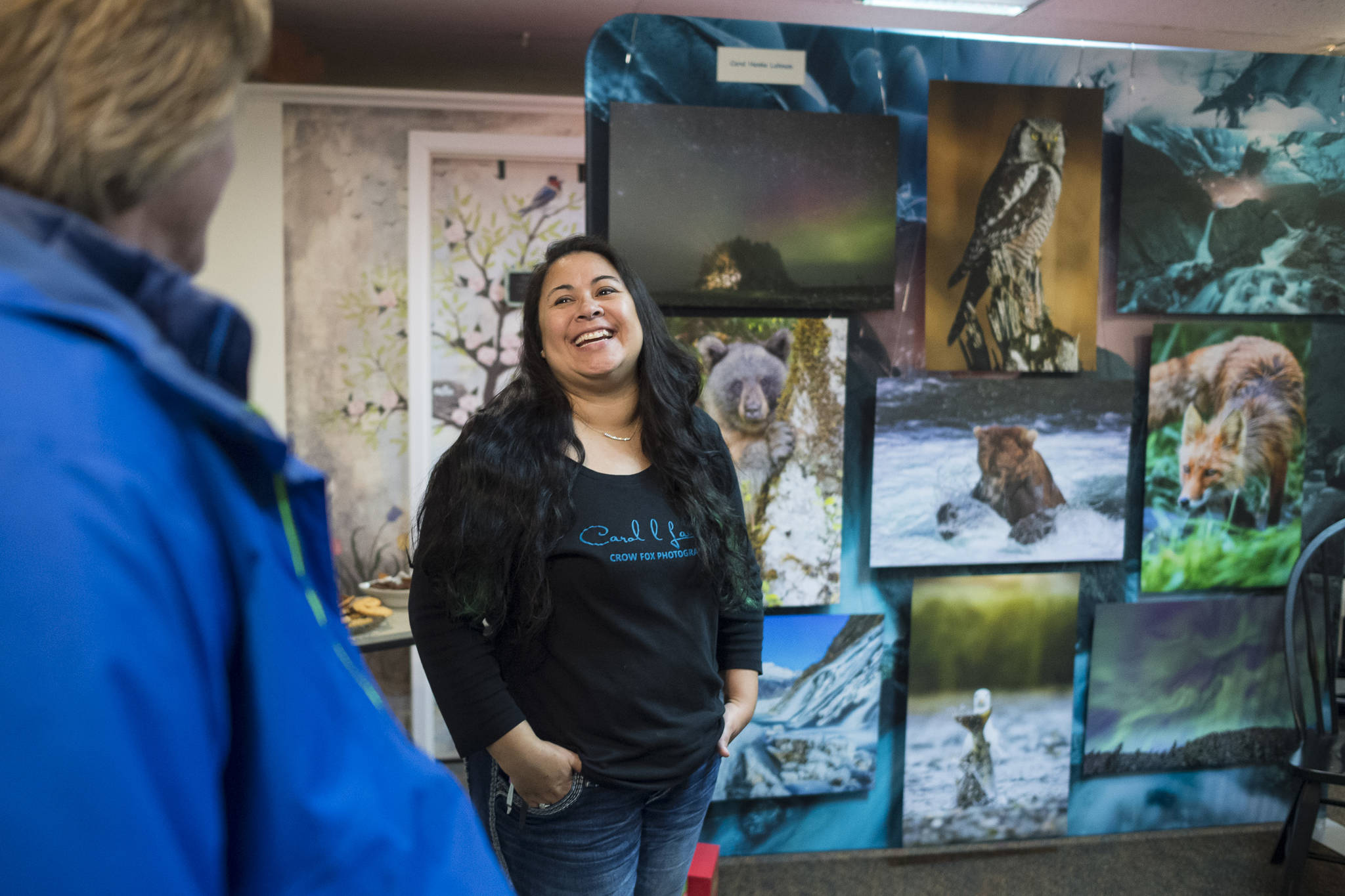 Carol Henke Lahnum, owner of Crow Fox Photography, visits with Matt Brown during Gallery Walk on Friday, Dec. 7, 2018. Henke Lahnum is part of “The Fearless Female Fotographers: Group Photography Exhibit” for Gallery Walk. (Michael Penn | Juneau Empire)