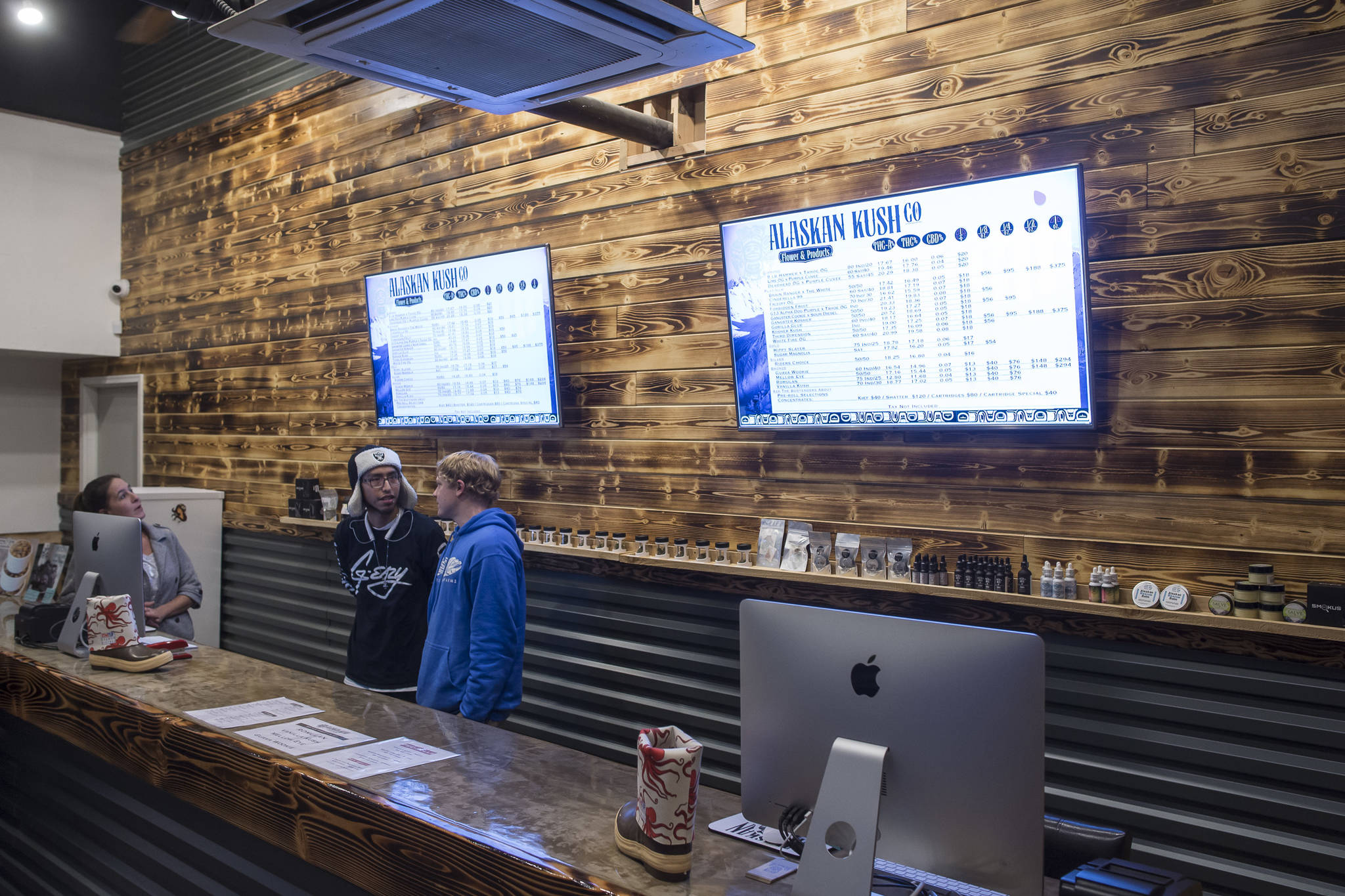 Employees man the counter at the Alaskan Kush Company on Franklin Street on Tuesday, Dec. 4, 2018. (Michael Penn | Juneau Empire)