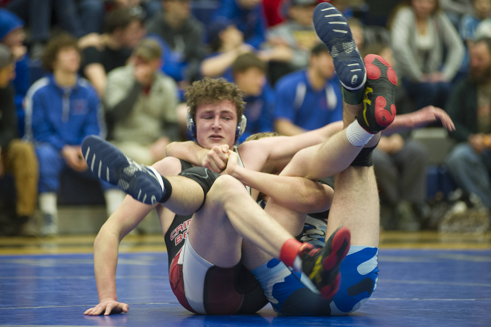 Juneau-Douglas’ Steven Ireland-Haight tries to free himself from Thunder Mountain’s Nick Nick Tipton’s hold during their 171-pound finals match in the Region V Division I Wrestling Championships at TMHS on Saturday, Dec. 8, 2018. Tipton earned a 4-2 decision to win the region title. (Nolin Ainsworth | Juneau Empire)