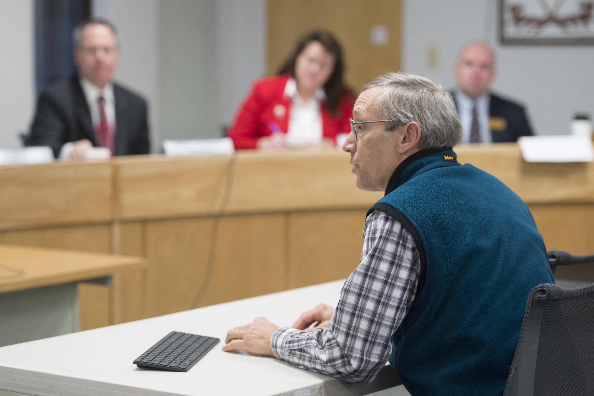 Doug Woodby, co-chair of climate action group @350 Juneau, speaks to the Alaska Permanent Fund Corporation’s Board of Trustees during its quarterly meeting in Juneau on Tuesday, Dec. 11, 2018. The local chapter of the national environmental group has been asking the trustees to divest from fossil fuel investments.