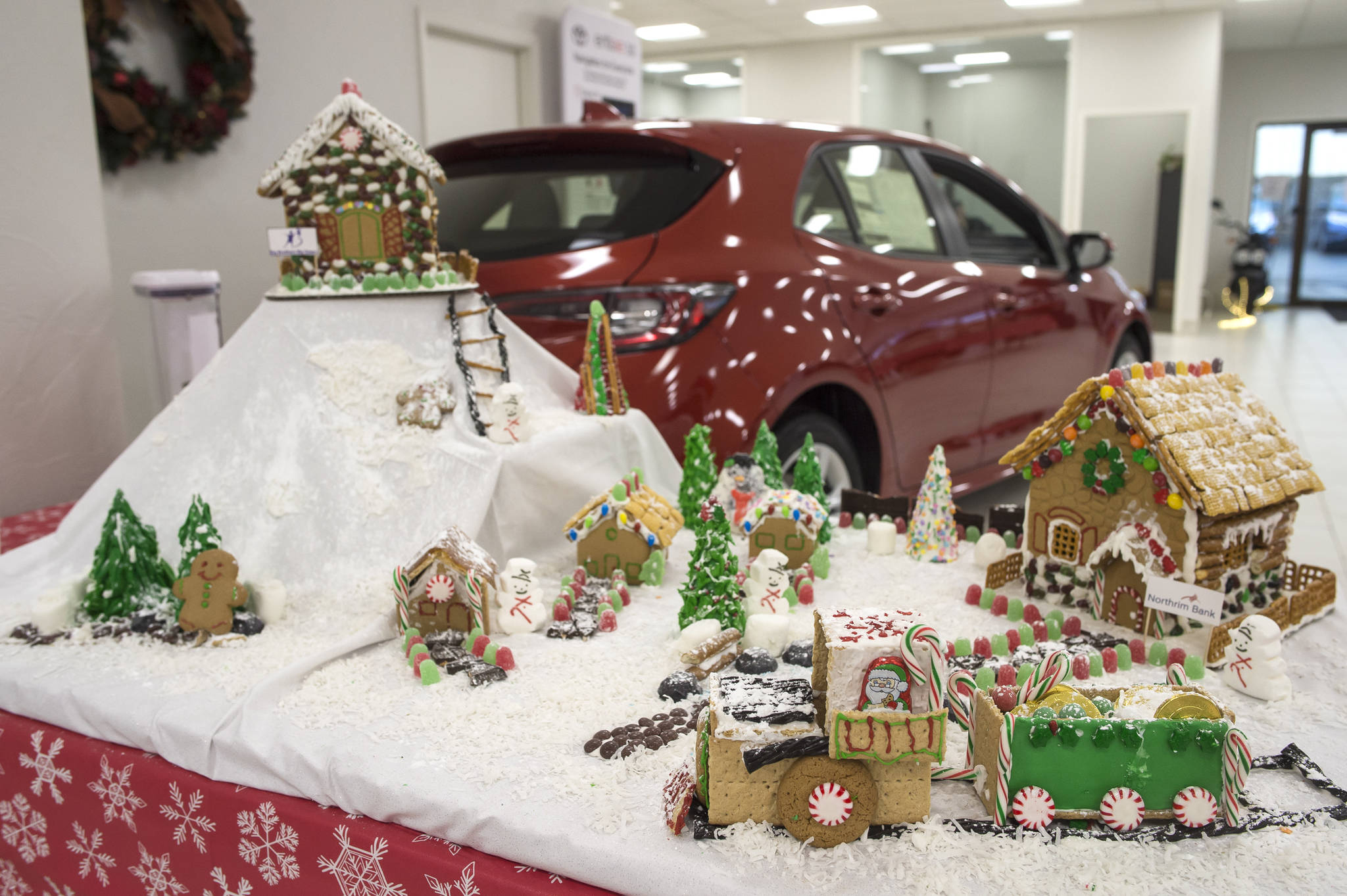 A gingerbread house entered by Northrim Bank sits on display at Mendenhall Auto on Wednesday, Dec. 12, 2018. The displays are a fundraiser for the Southeast Alaska Foodbank. (Michael Penn | Juneau Empire)