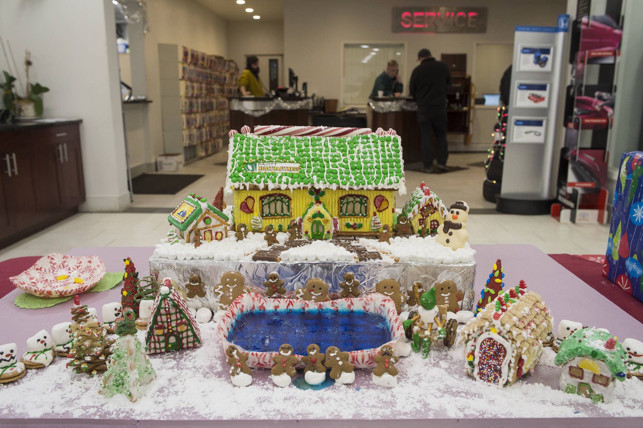 A gingerbread house entered by Pavitt’s Health & Fitness sits on display at Mendenhall Auto on Wednesday, Dec. 12, 2018. The displays are a fundraiser for the Southeast Alaska Foodbank. (Michael Penn | Juneau Empire)