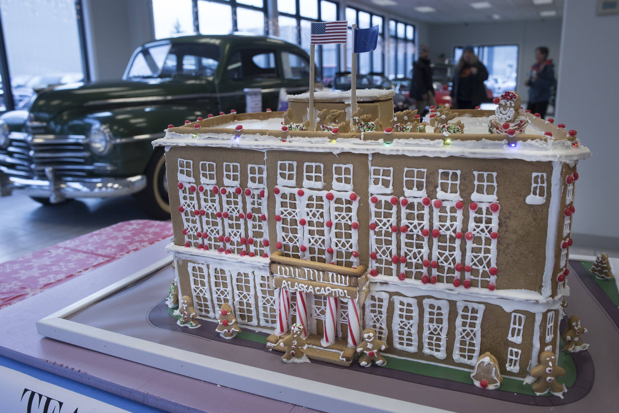 A gingerbread house representation of the Alaska State Capitol entered by Jensen Yorba Lott, Inc. sits on display at Mendenhall Auto on Wednesday, Dec. 12, 2018. The displays are a fundraiser for the Southeast Alaska Foodbank. (Michael Penn | Juneau Empire)
