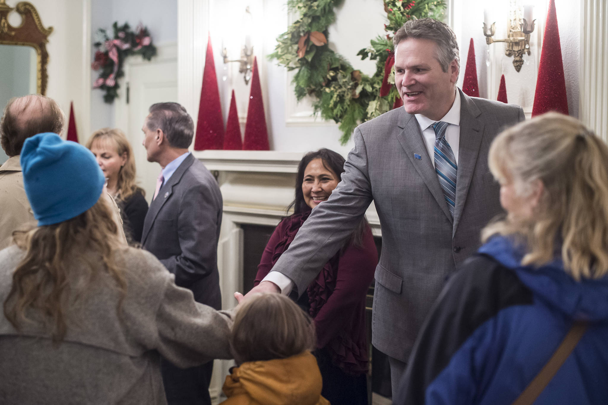Gov. Mike Dunleavy and his wife, Rose, welcome Juneau residents at the Governor’s Open House on Tuesday, Dec. 11, 2018. (Michael Penn | Juneau Empire)