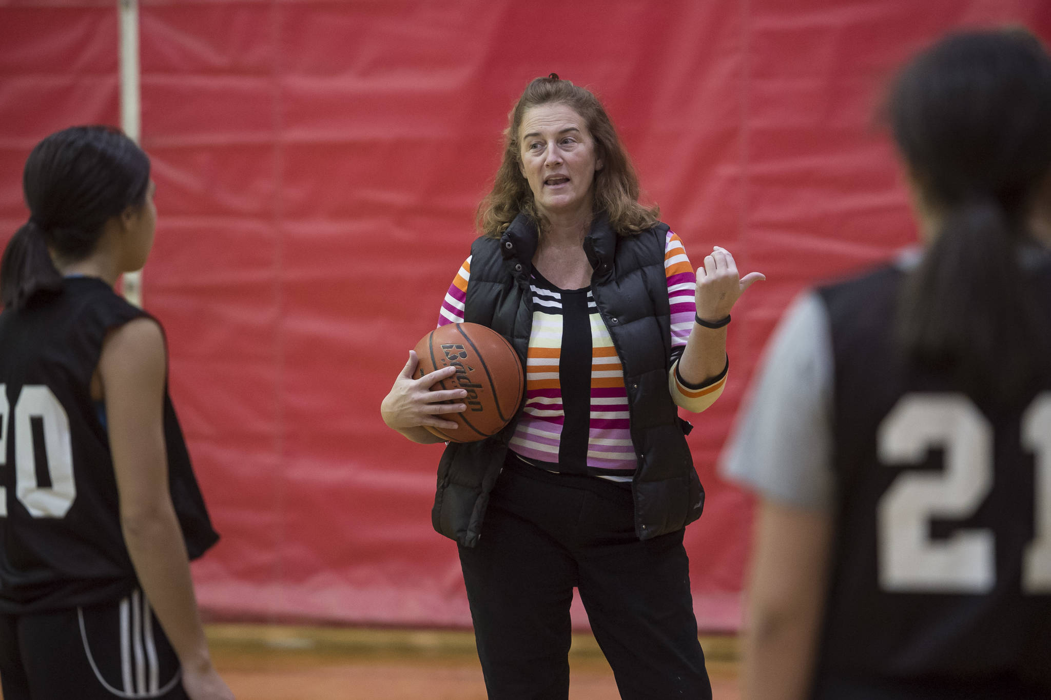 Coach Lesslie Knight directs players during Juneau-Douglas High School girls varsity practice on Thursday, Dec. 6, 2018. (Michael Penn | Juneau Empire)