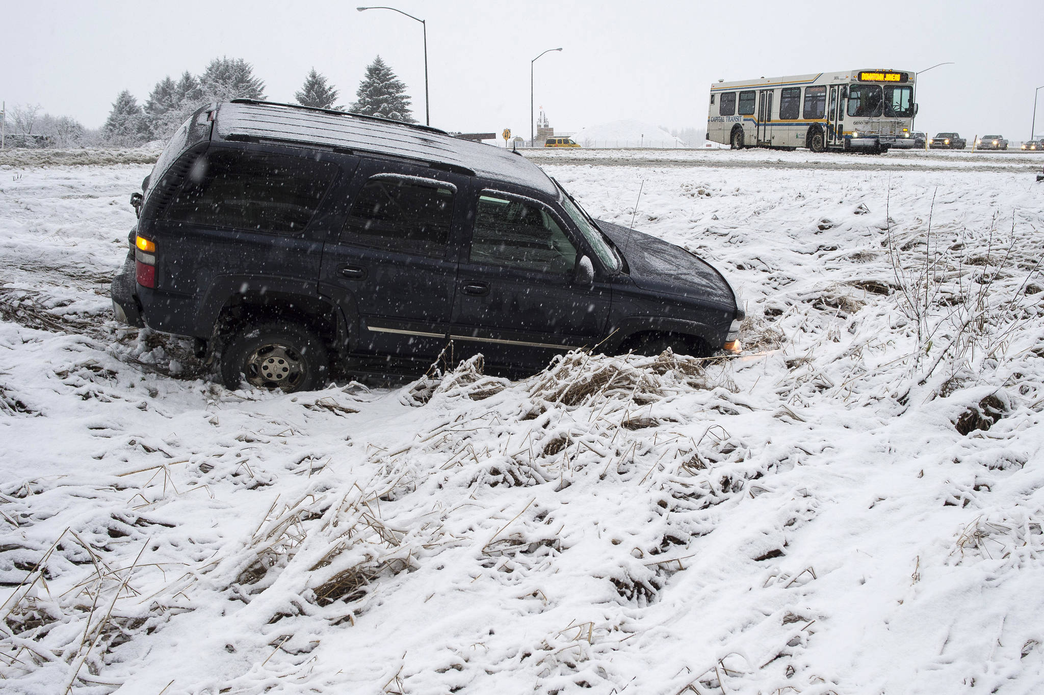 A vehicle in the ditch at the intersection of Egan Drive and Yandukin Drive near Fred Meyer on Thursday, Dec. 13, 2018. (Michael Penn | Juneau Empire)