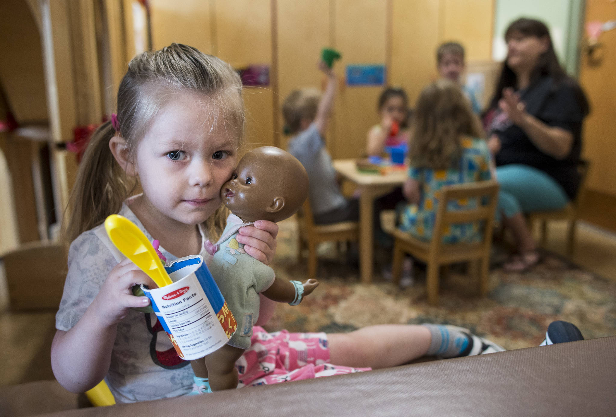 Talia, 3, plays with a doll at Gold Creek Child Development Center on Thursday, May 24, 2018. (Michael Penn | Juneau Empire)