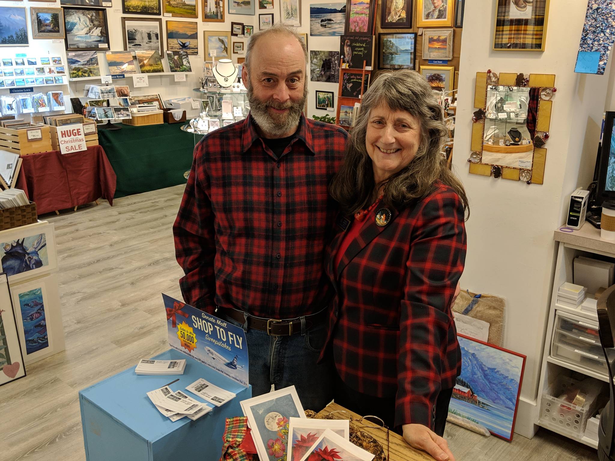 Mark Vinsel and Dianne Anderson, Juneau artists and husband and wife, are planning to retire from Juneau’s professional arts community and eventually move from the area. Here they stand in Juneau Artists Gallery Wednesday, Dec. 19, 2018. (Ben Hohenstatt | Capital City Weekly)