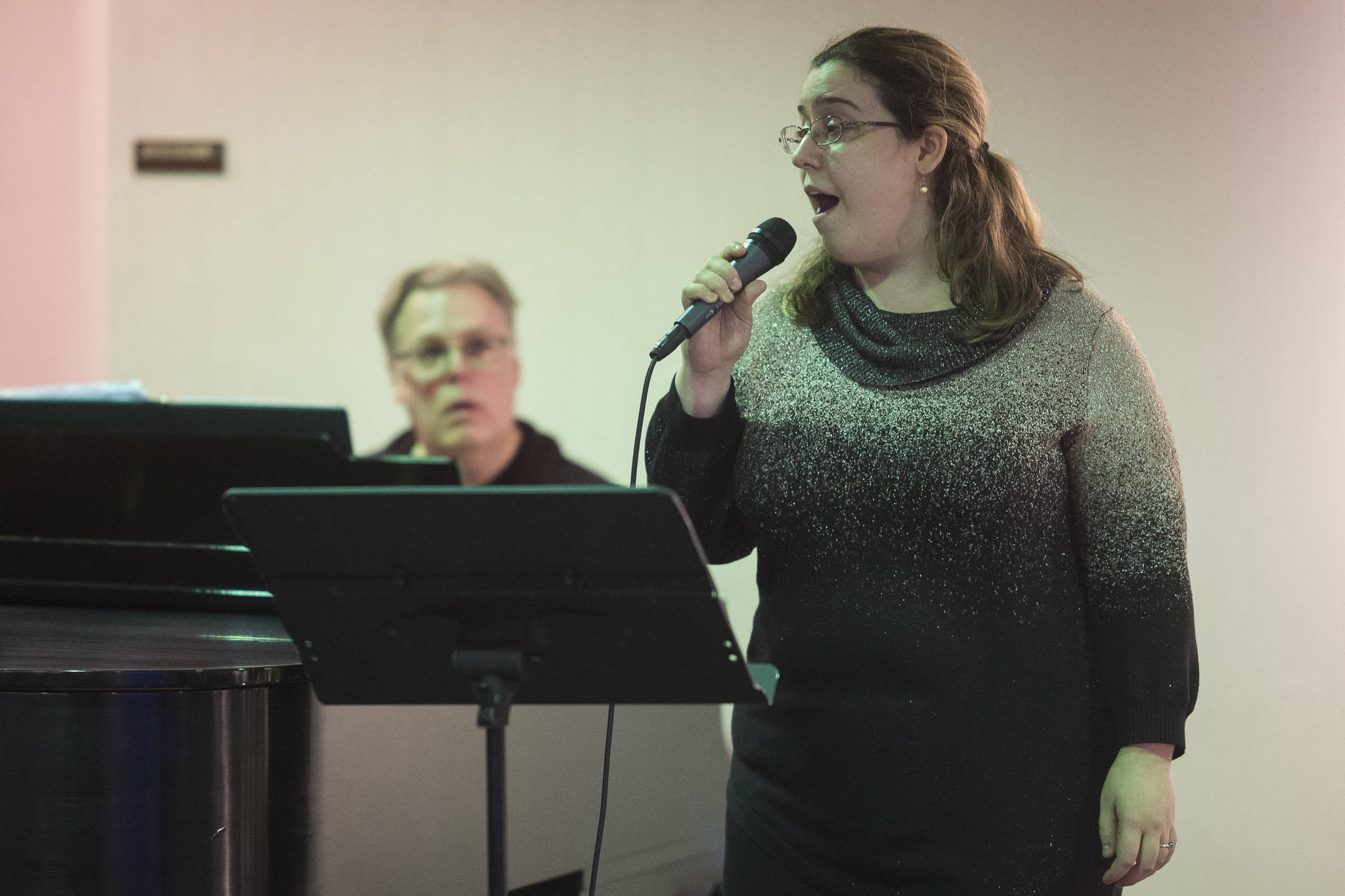 Juneau Cabaret singer Kristina Paulick sings for Juneau residents as she is accompanied by Tom Locher during the third annual Holiday Extravaganza at Centennial Hall on Wednesday, Dec. 19, 2018. (Michael Penn | Juneau Empire)