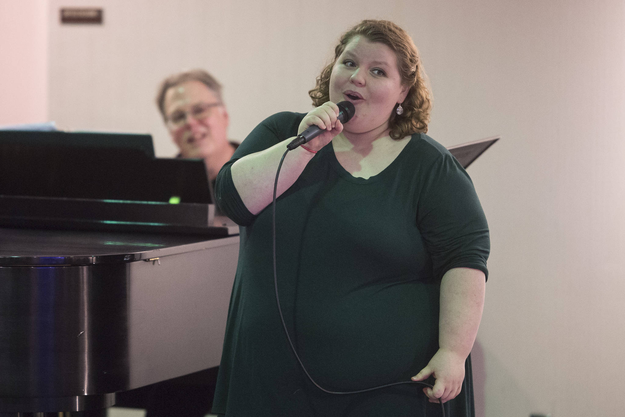 Juneau Cabaret singer Aria Moore sings for Juneau residents as she is accompanied by Tom Locher during the third annual Holiday Extravaganza at Centennial Hall on Wednesday, Dec. 19, 2018. (Michael Penn | Juneau Empire)