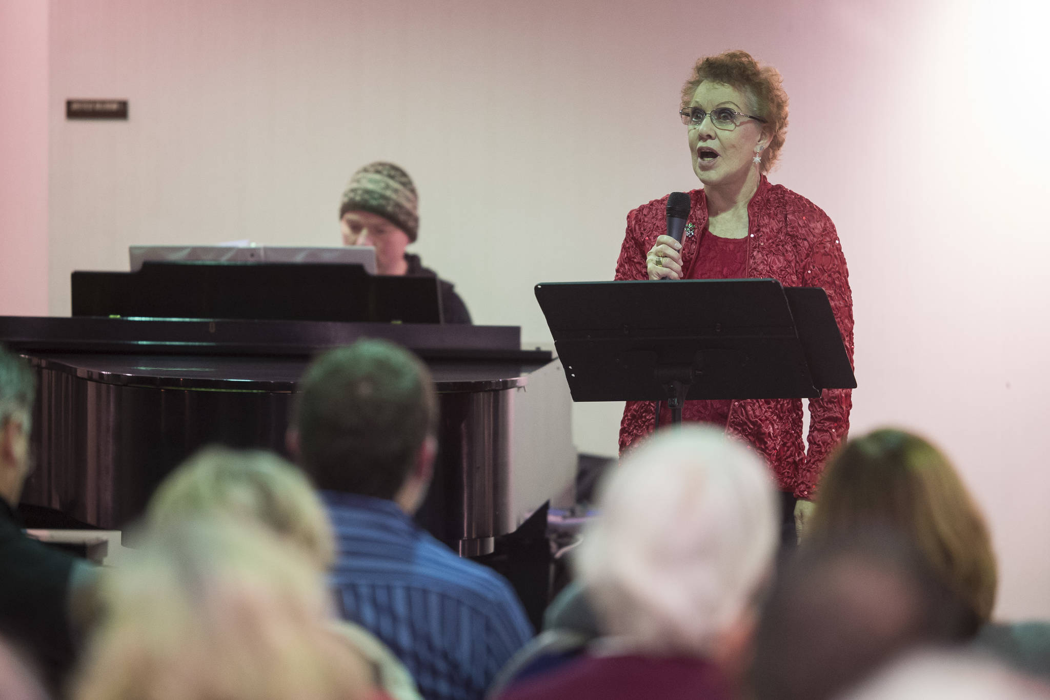 Juneau Cabaret singer Ardyne Womack sings for Juneau residents as she is accompanied by Luke Weld during the third annual Holiday Extravaganza at Centennial Hall on Wednesday, Dec. 19, 2018. (Michael Penn | Juneau Empire)