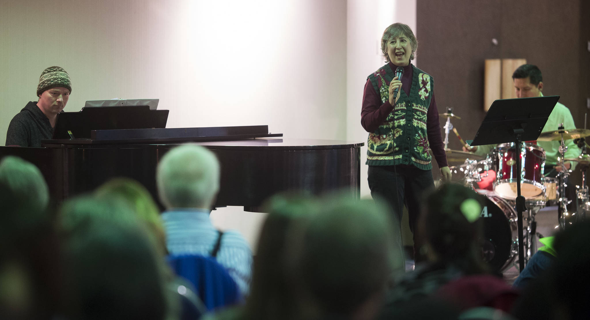 Juneau Cabaret singer Therese Thibodeau sings for Juneau residents as she is accompanied by Luke Weld and David Sheakley-Early during the third annual Holiday Extravaganza at Centennial Hall on Wednesday, Dec. 19, 2018. (Michael Penn | Juneau Empire)