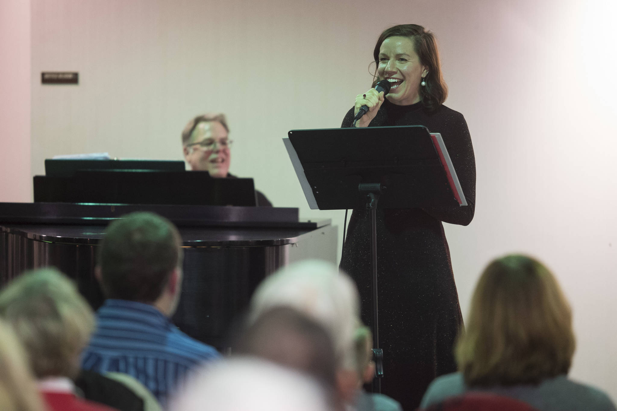 Juneau Cabaret singer Allison Holtkamp sings for Juneau residents as she is accompanied by Tom Locher during the third annual Holiday Extravaganza at Centennial Hall on Wednesday, Dec. 19, 2018. (Michael Penn | Juneau Empire)