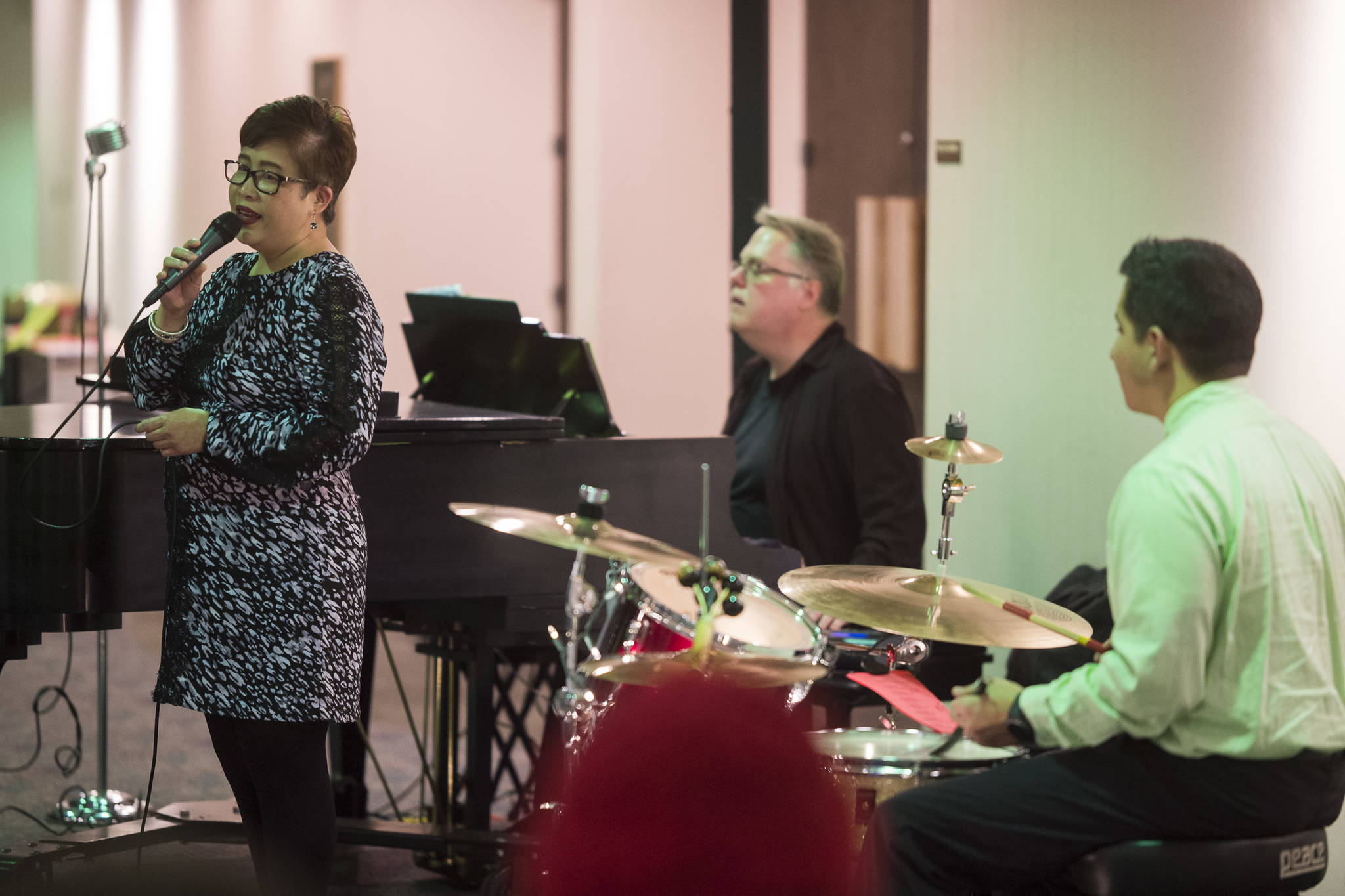 Juneau Cabaret singer Joselyn Ribao sings for Juneau residents as she is accompanied by Tom Locher and David Sheakley-Early during the third annual Holiday Extravaganza at Centennial Hall on Wednesday, Dec. 19, 2018. (Michael Penn | Juneau Empire)