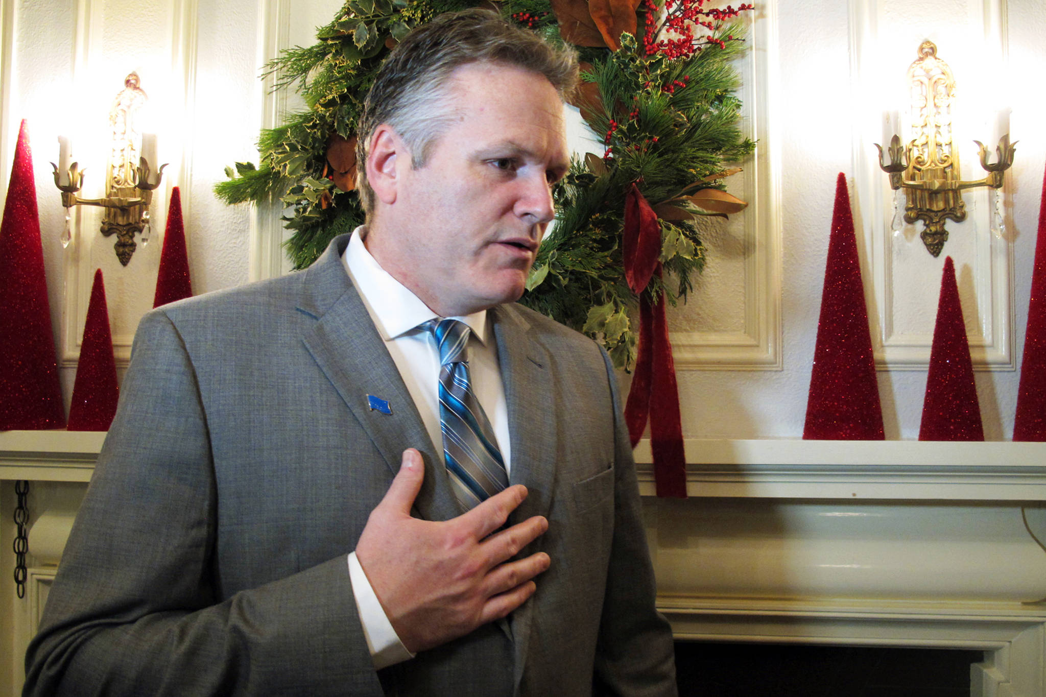 Alaska Gov. Mike Dunleavy answers a reporter’s question before the start of a holiday open house at the governor’s mansion on Tuesday, Dec. 11, 2018, in Juneau, Alaska. The open house doubled as an inaugural event for Dunleavy, who took office last week. (Becky Bohrer | Associated Press File)