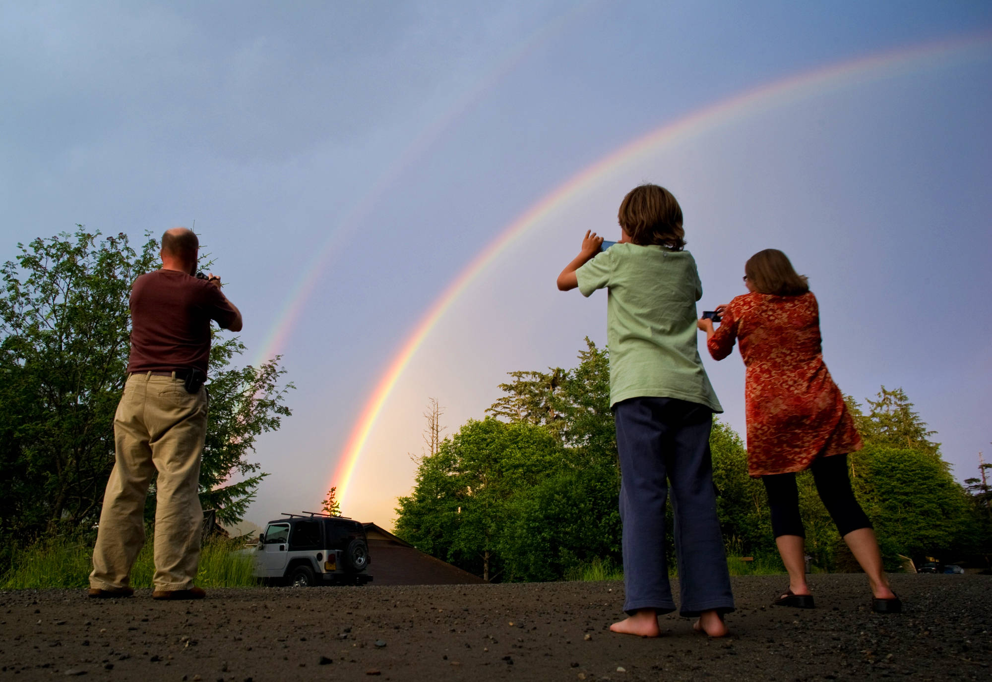 In this July 2013 photo, Juneau residents photograph a particularly intense rainbow in North Doulglas . (Michael Penn | Juneau Empire File)