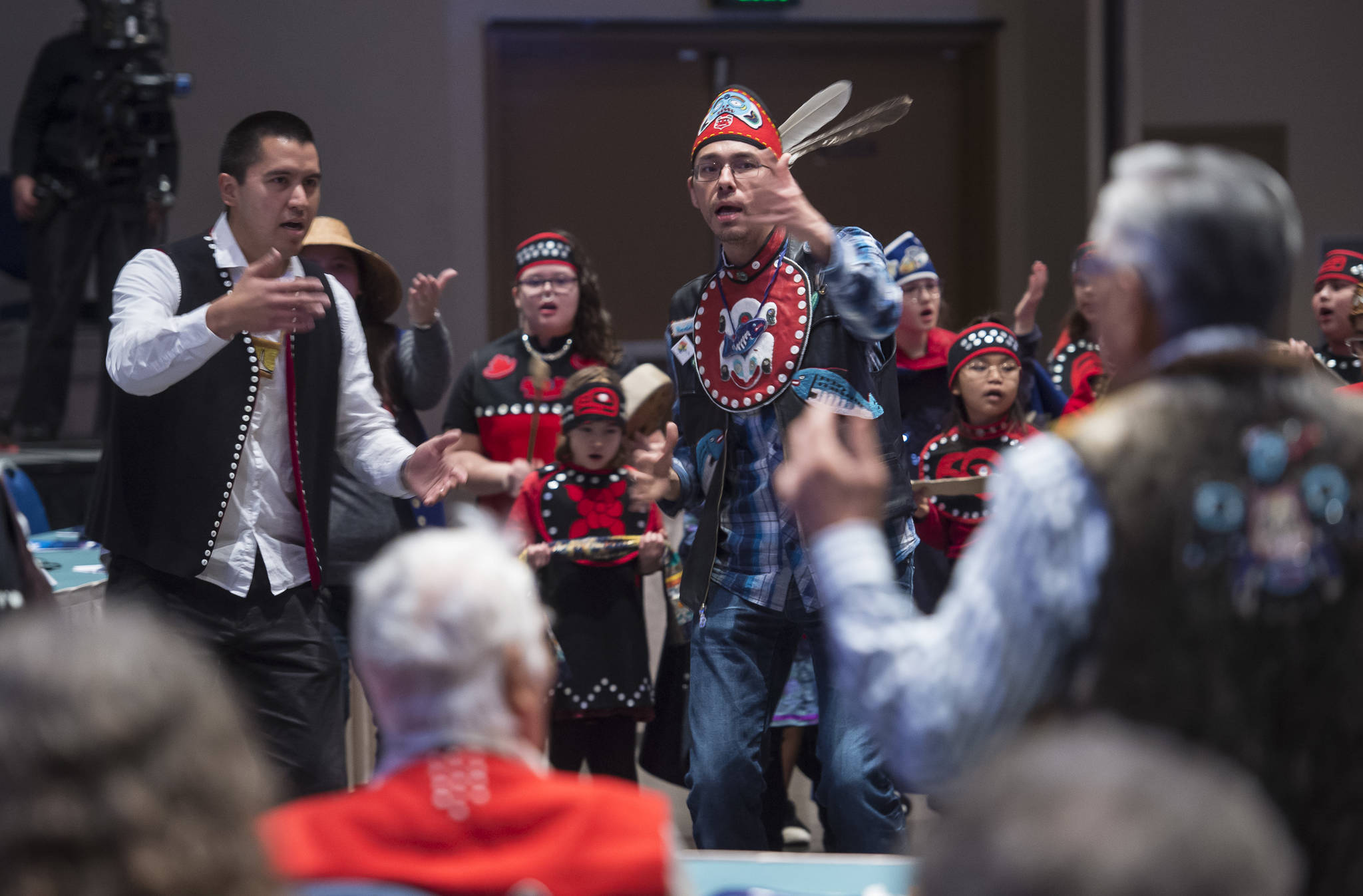 Tlingit Culture Language and Literacy Dance Group instructors Joshua Jackson, left, and Hans Chester from Harborview Elementary School dance with their students during the Voices of Our Ancestors Language Summit at Centennial Hall on Tuesday, Nov. 13, 2018. (Michael Penn | Juneau Empire)