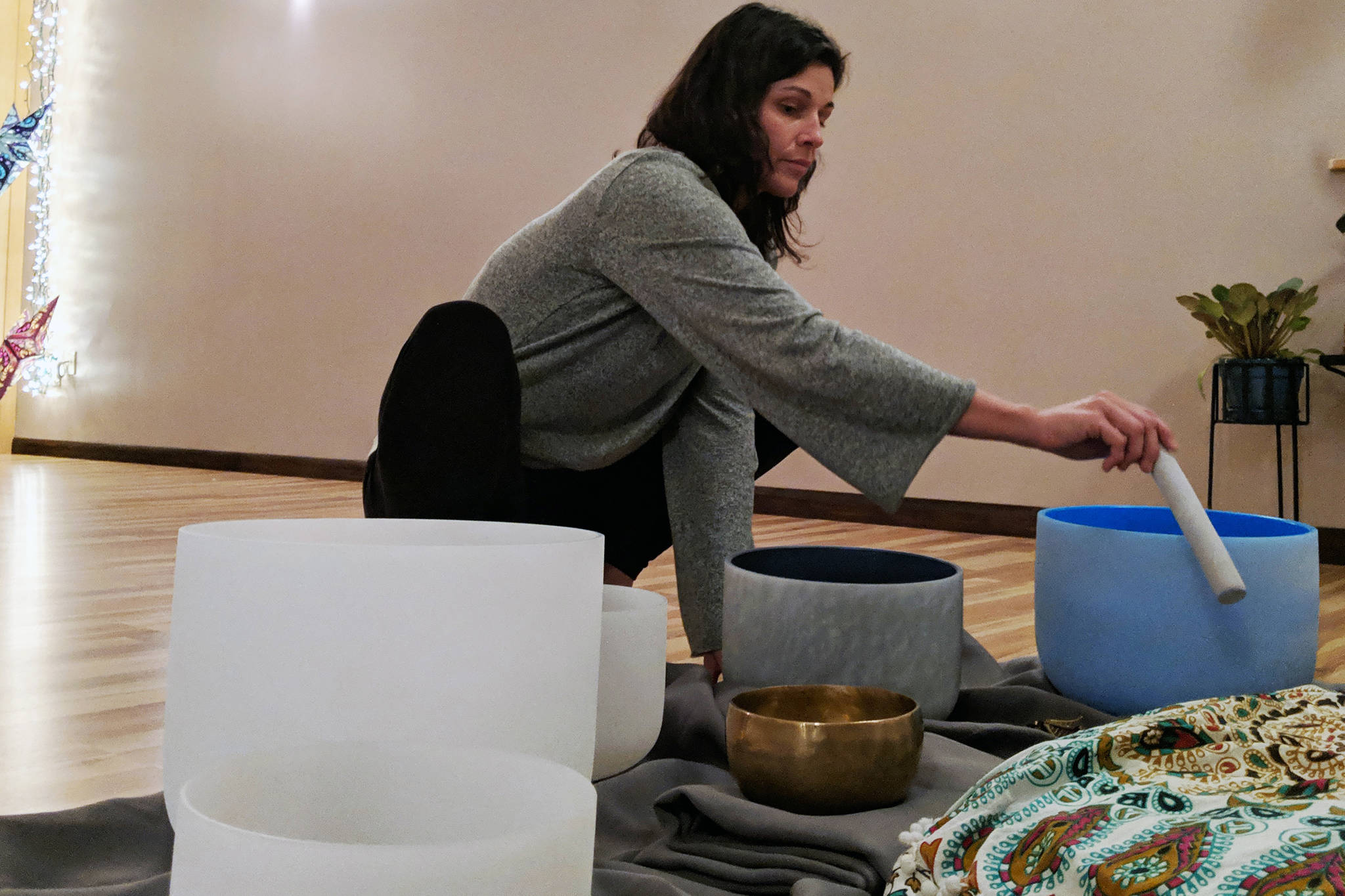 Lindsay Foreman, who lead a winter solstice sound bath at The Yoga Path, runs a foam wand around the rim of a singing bowl before the Dec. 21, 2018 event.
