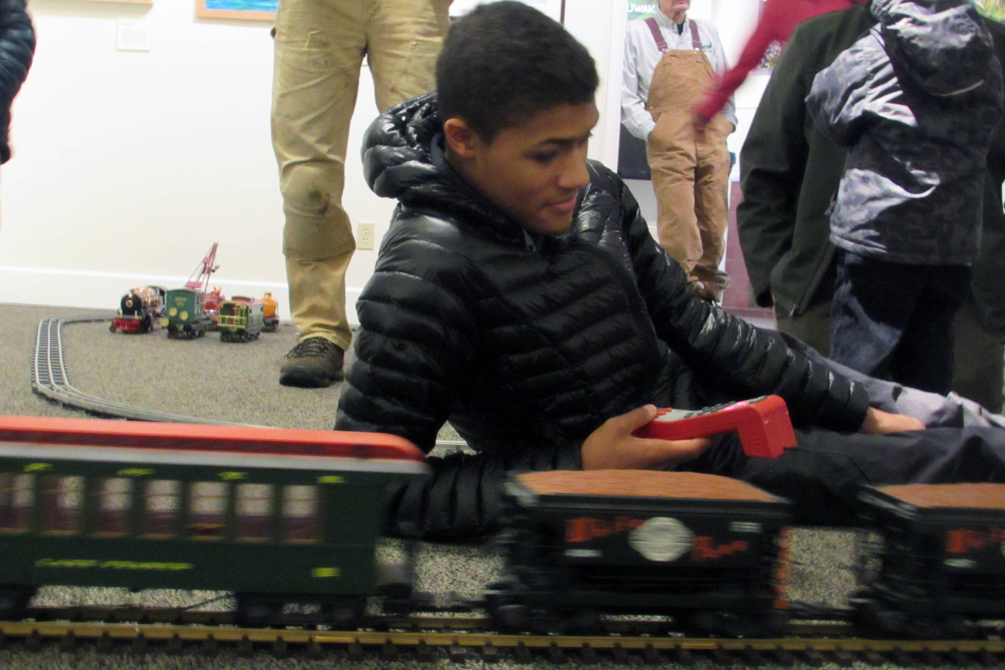Marion McQueen IV handles the controls for a scale model of the White Pass & Yukon Route Railway train Saturday, Dec. 22, 2018 at Juneau-Douglas City Museum. (Ben Hohenstatt | Capital City Weekly)