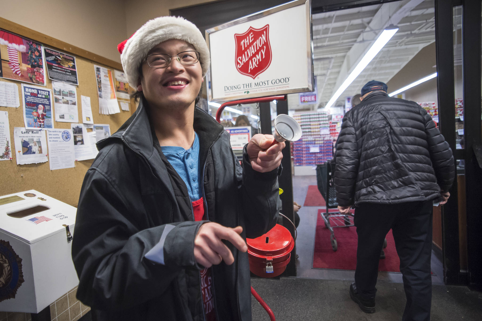 FuBao Goldsberry, 19, rings the bell for The Salvation Army at Foodland IGA on Friday, Dec. 21, 2018. (Michael Penn | Juneau Empire)