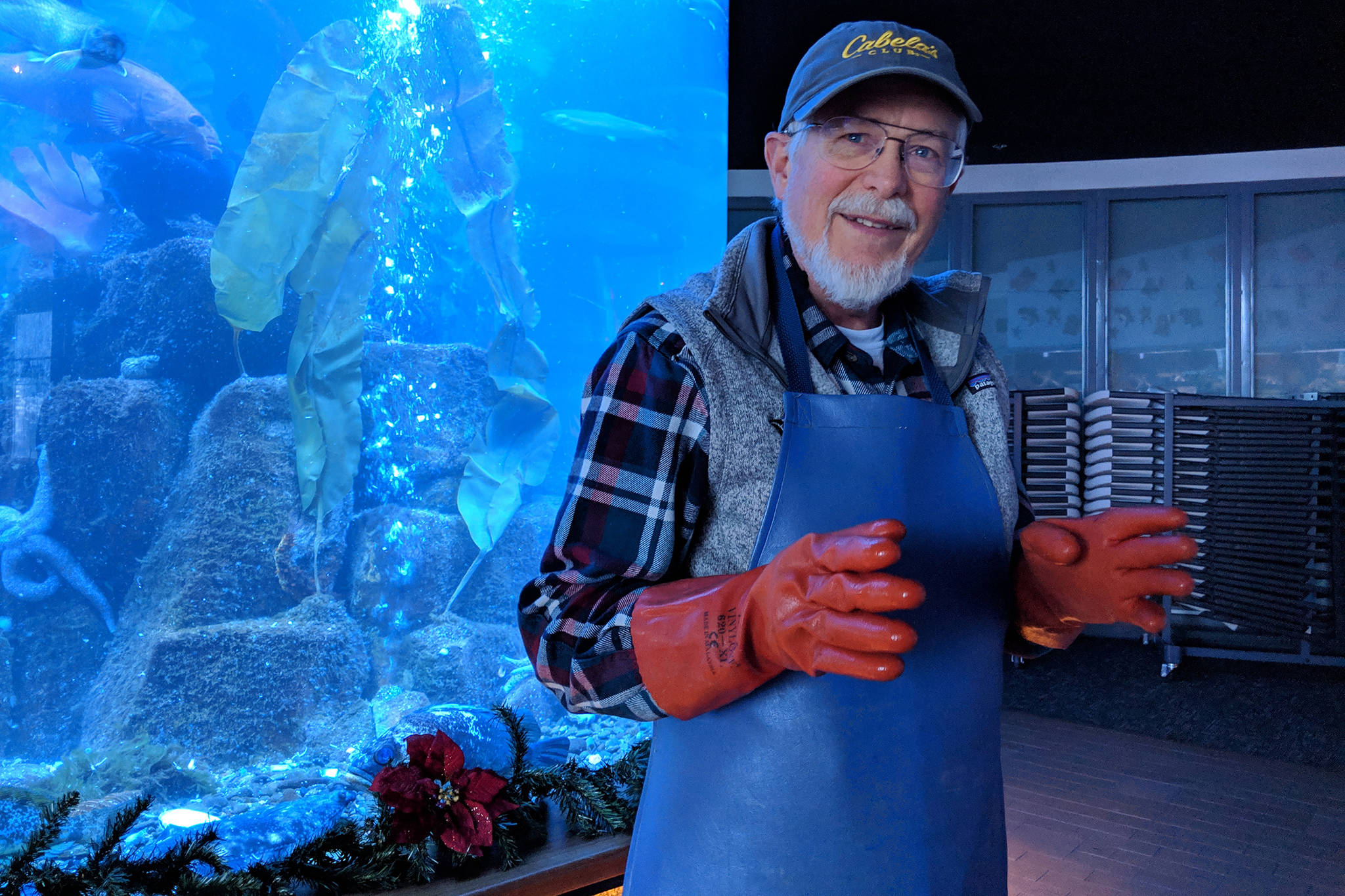 Rich Mattson, who retired after nearly 31 years with Douglas Island Pink And Chum, smiles while recalling an earlier engagement with a giant pacific octopus during his last shift, Dec. 24, 2018. (Ben Hohenstatt | Capital City Weekly)