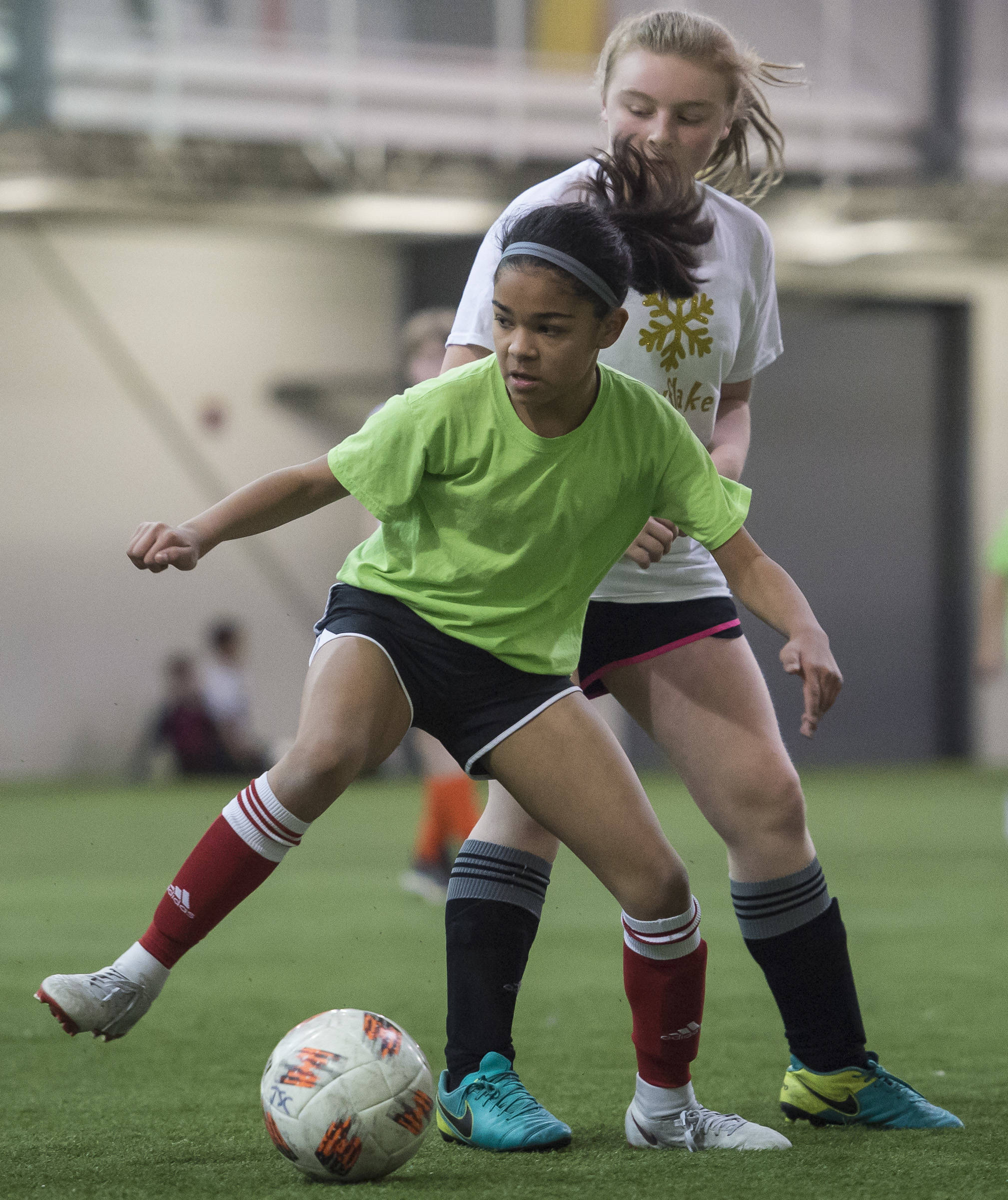 Missile Toes’ Cadence Plummer controls the ball against Snowflake United’s Isabelle Powers at the annual Holiday Cup Soccer Tournament at the Wells Fargo Dimond Park Field House on Wednesday, Dec. 26, 2018. (Michael Penn | Juneau Empire)