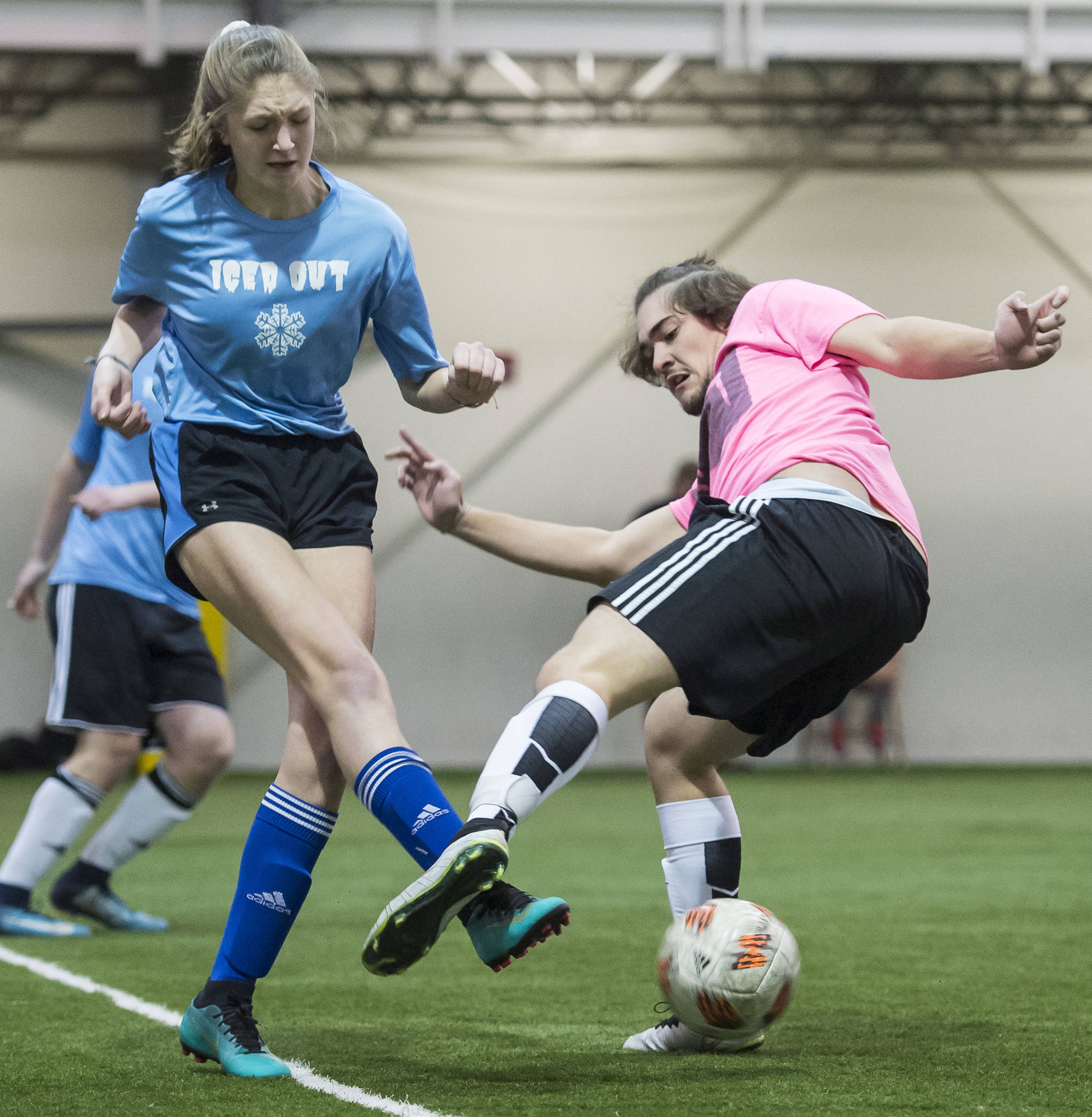Iced Out’s Brooke Sanford kicks the ball away from Pit Vipers’ Asher Aanrud at the annual Holiday Cup Soccer Tournament at the Wells Fargo Dimond Park Field House on Wednesday, Dec. 26, 2018. (Michael Penn | Juneau Empire)