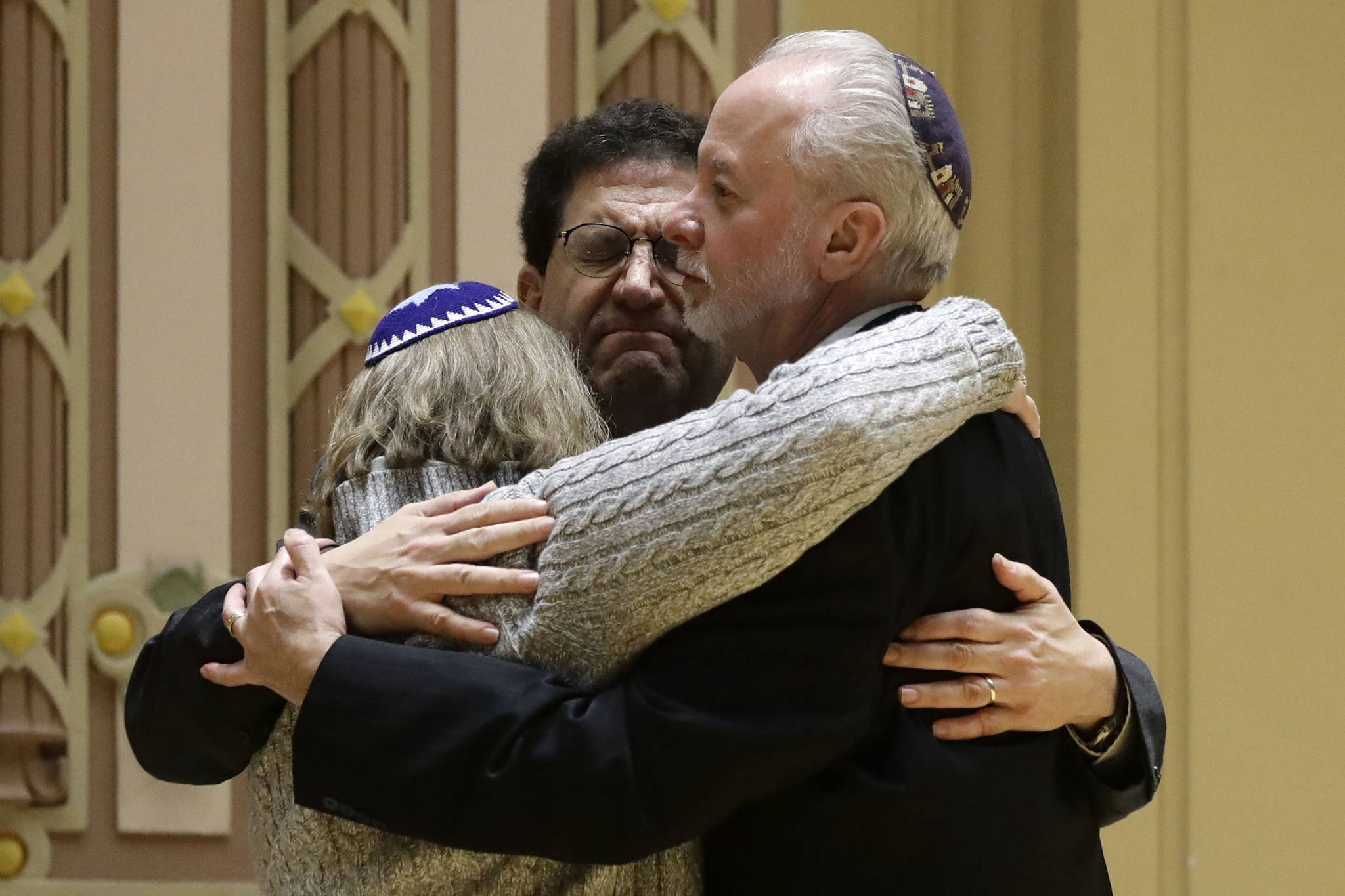 In this Oct. 28, 2018 photo, Rabbi Jeffrey Myers, right, of Tree of Life/Or L’Simcha Congregation hugs Rabbi Cheryl Klein, left, of Dor Hadash Congregation and Rabbi Jonathan Perlman during a community gathering held in the aftermath of a deadly shooting at the Tree of Life Synagogue in Pittsburgh. As the Jewish community grieved, Myers took a leading role during public memorials and presided over seven funerals in the space of less than a week. (Matt Rourke | Associated Press File)