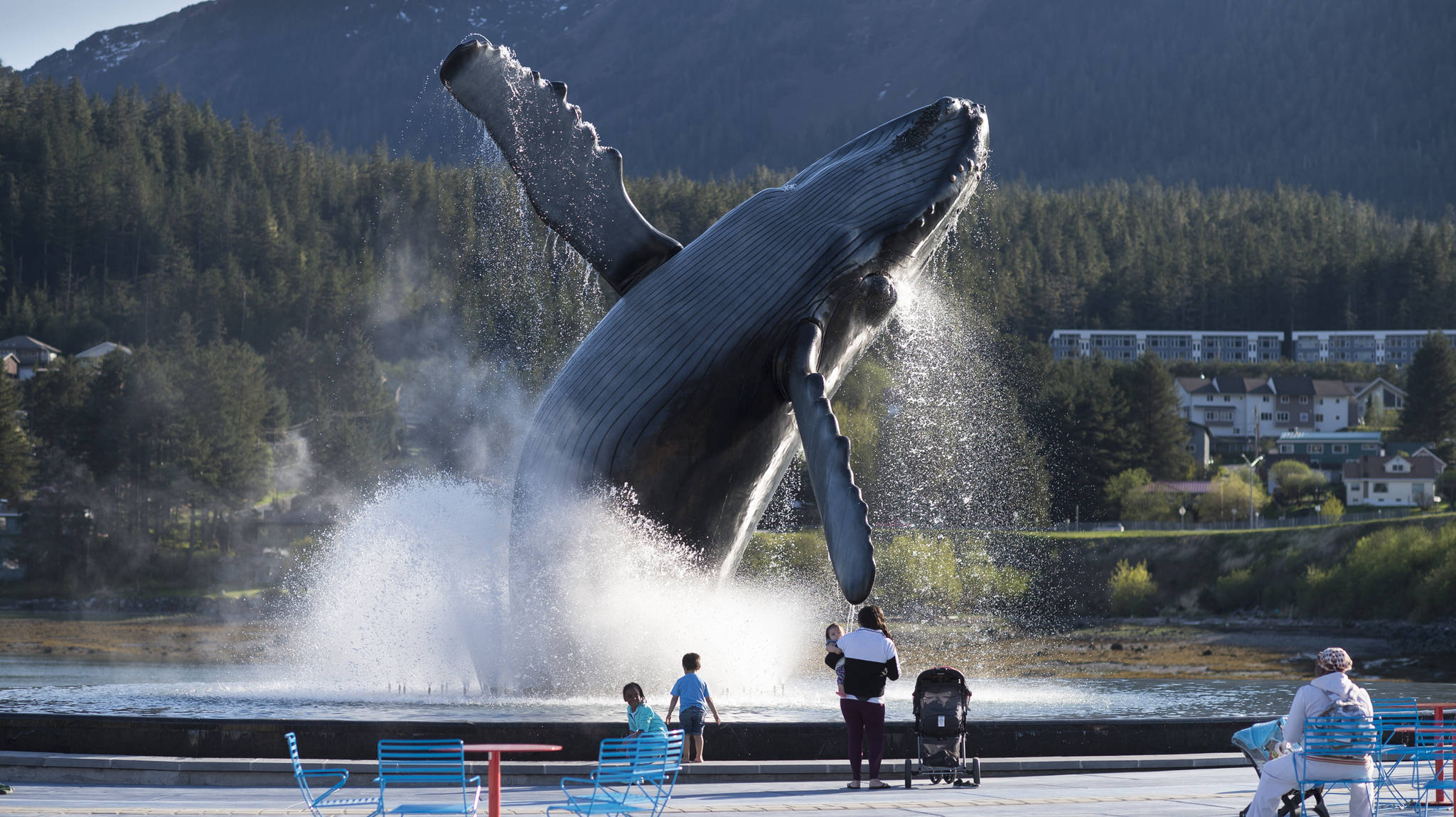 Juneau residents turn out to watch the whale fountain in action on Tuesday, May 15, 2018. (Michael Penn | Juneau Empire)