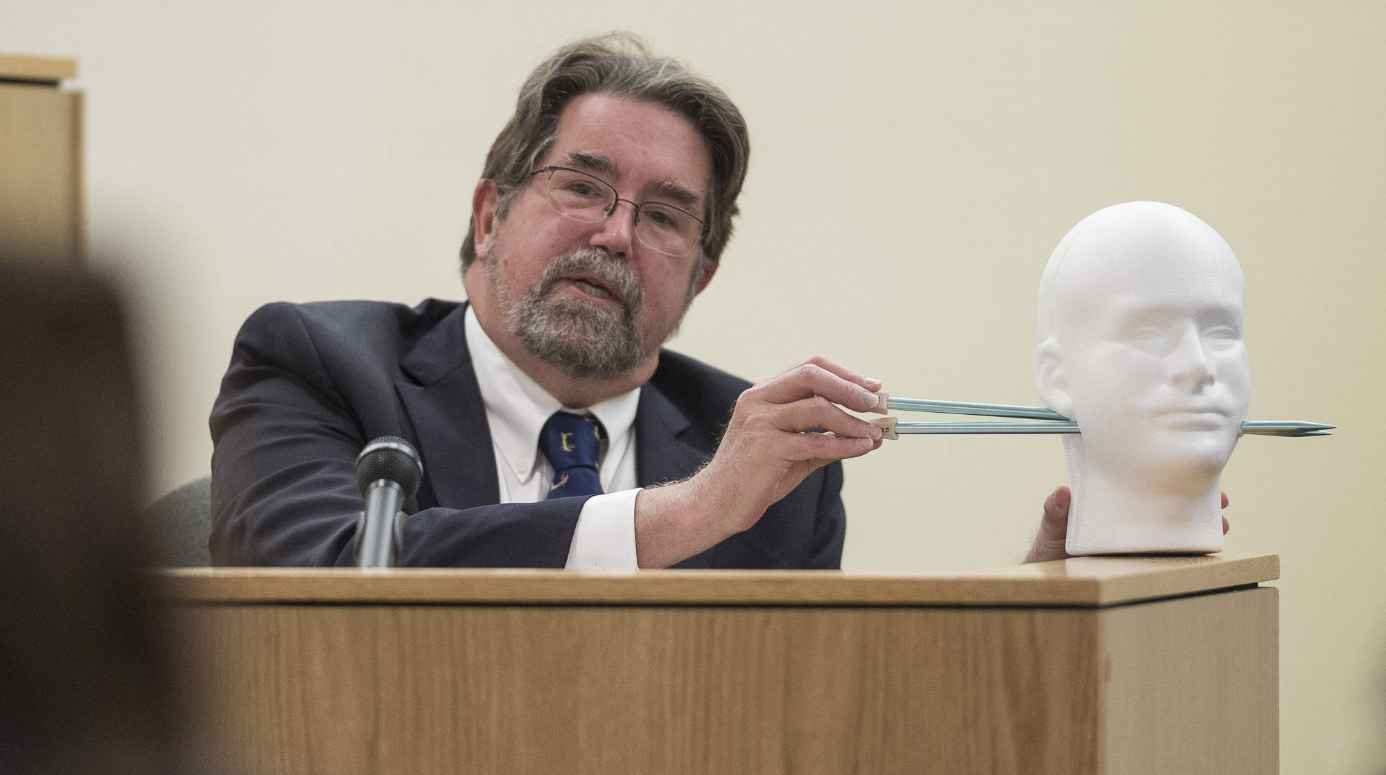 Dr. Todd Grey, a retired medical examiner, testifies to the possible path of the bullet wounds in the trial of Mark De Simone in Juneau Superior Court on Monday, May 6, 2018. De Simone was found guilty of killing Duilio Antonio “Tony” Rosales during a hunting trip in Excursion Inlet in 2016. (Michael Penn | Juneau Empire File)