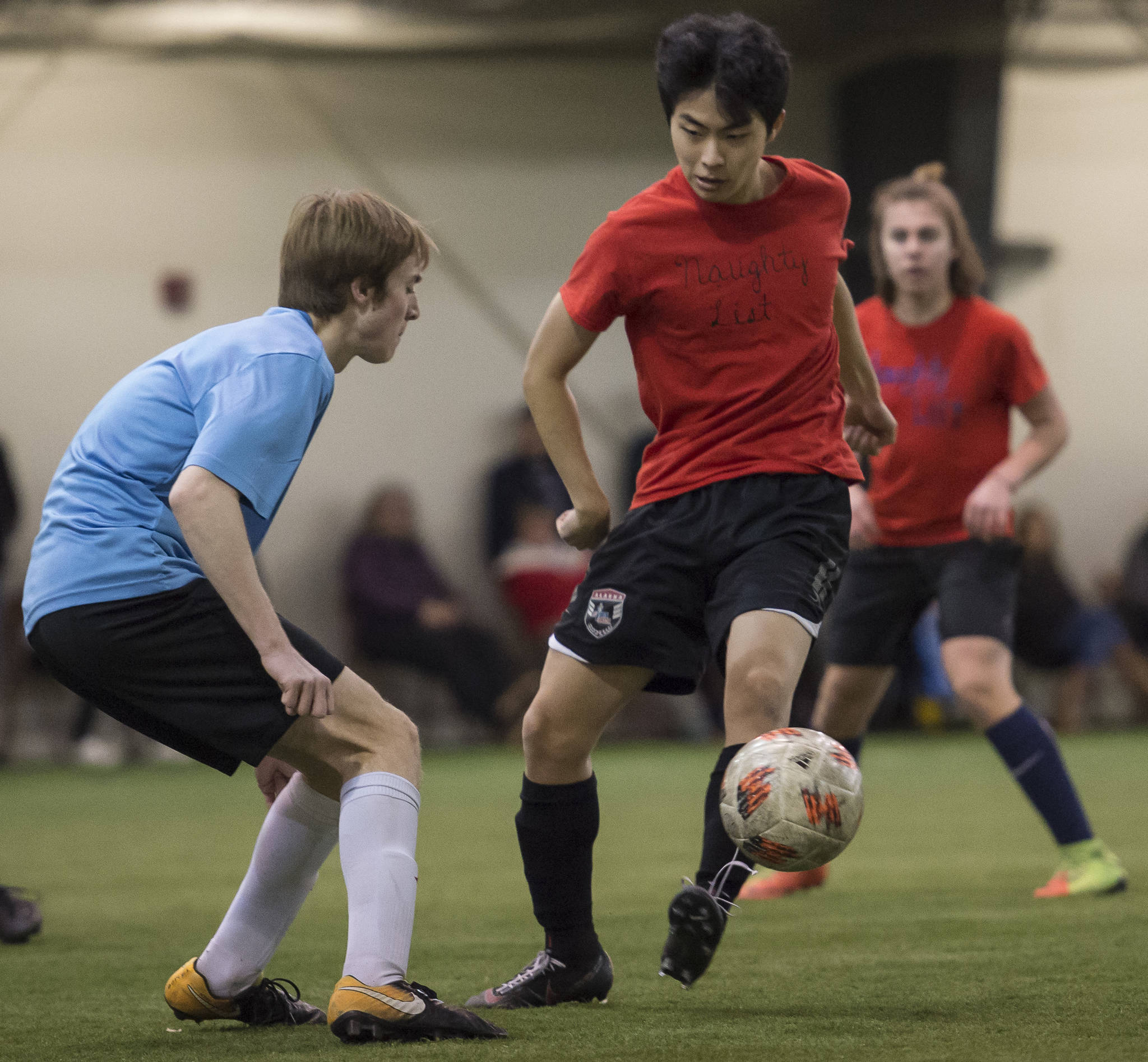 Iced Out, blue, competes against Naughty List, red, in the finals of the high school division at the annual Holiday Cup Soccer Tournament at the Wells Fargo Dimond Park Field House on Monday, Dec. 31, 2018. Iced Out won 8-2. (Michael Penn | Juneau Empire)