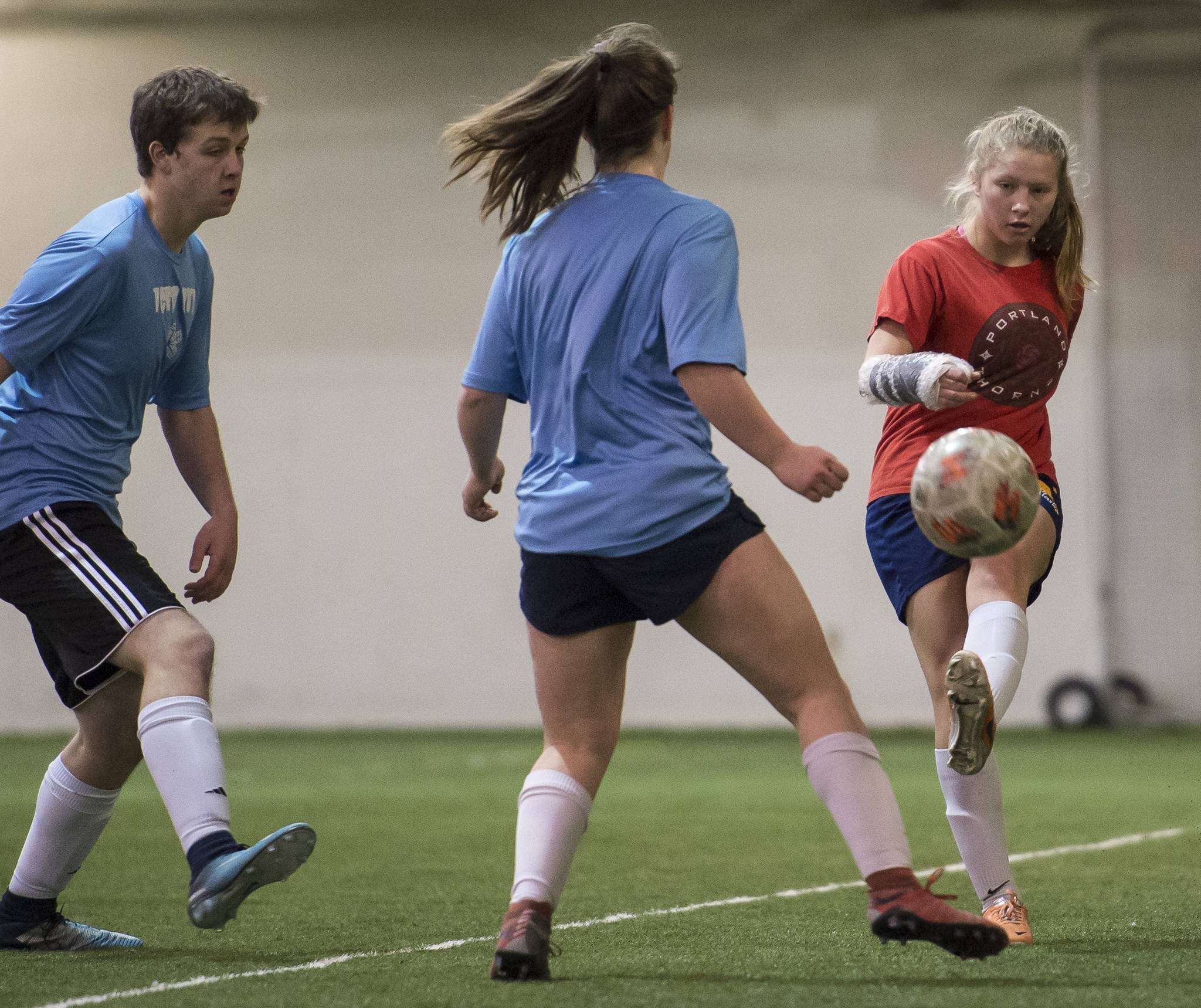 Iced Out, blue, competes against Naughty List, red, in the finals of the high school division at the annual Holiday Cup Soccer Tournament at the Wells Fargo Dimond Park Field House on Monday, Dec. 31, 2018. Iced Out won 8-2. (Michael Penn | Juneau Empire)