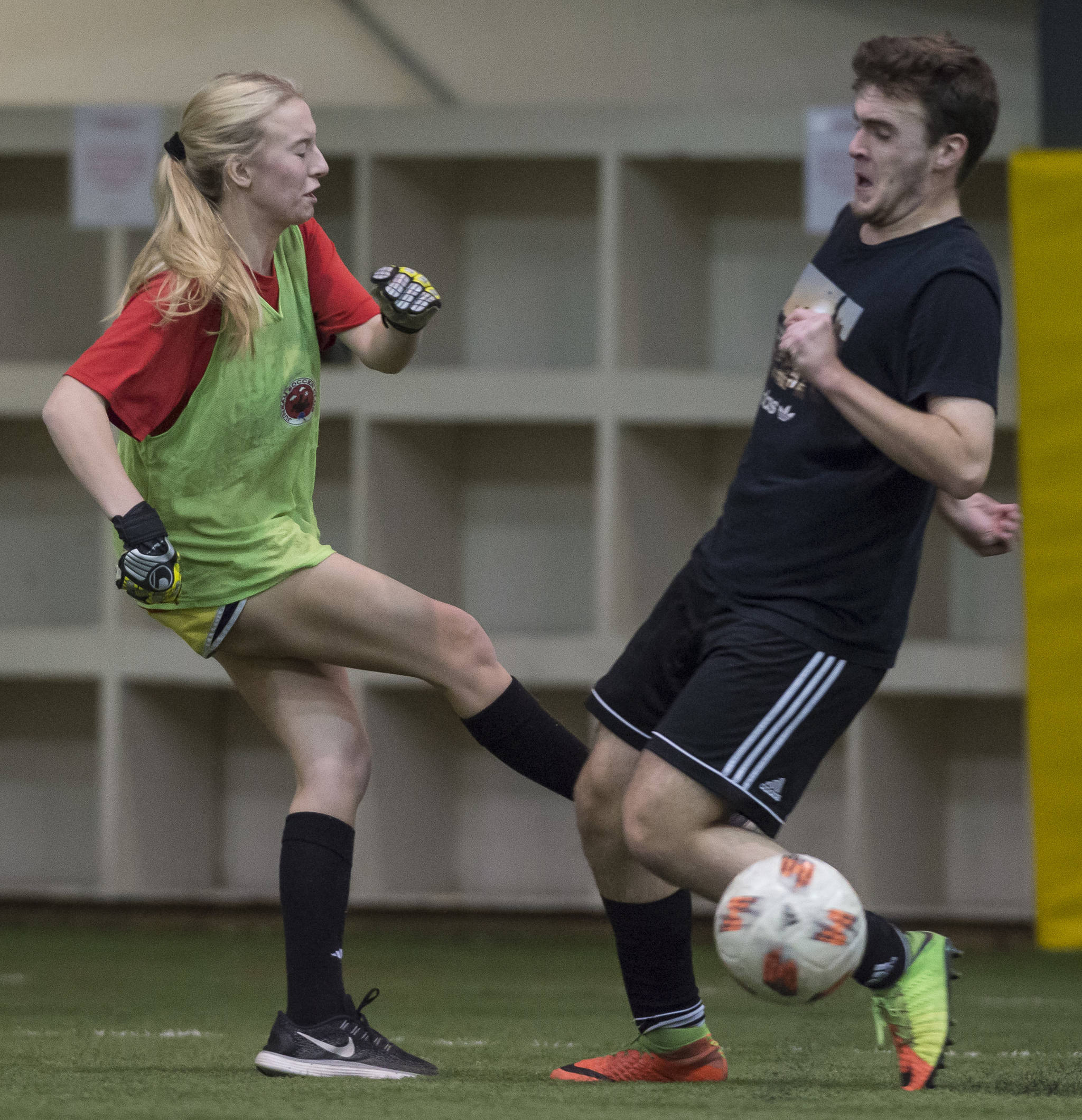 Grinch Gang, red, competes against Black Ice, black, in the finals of the senior division at the annual Holiday Cup Soccer Tournament at the Wells Fargo Dimond Park Field House on Monday, Dec. 31, 2018. The Grinch Gang won 8-2. (Michael Penn | Juneau Empire)