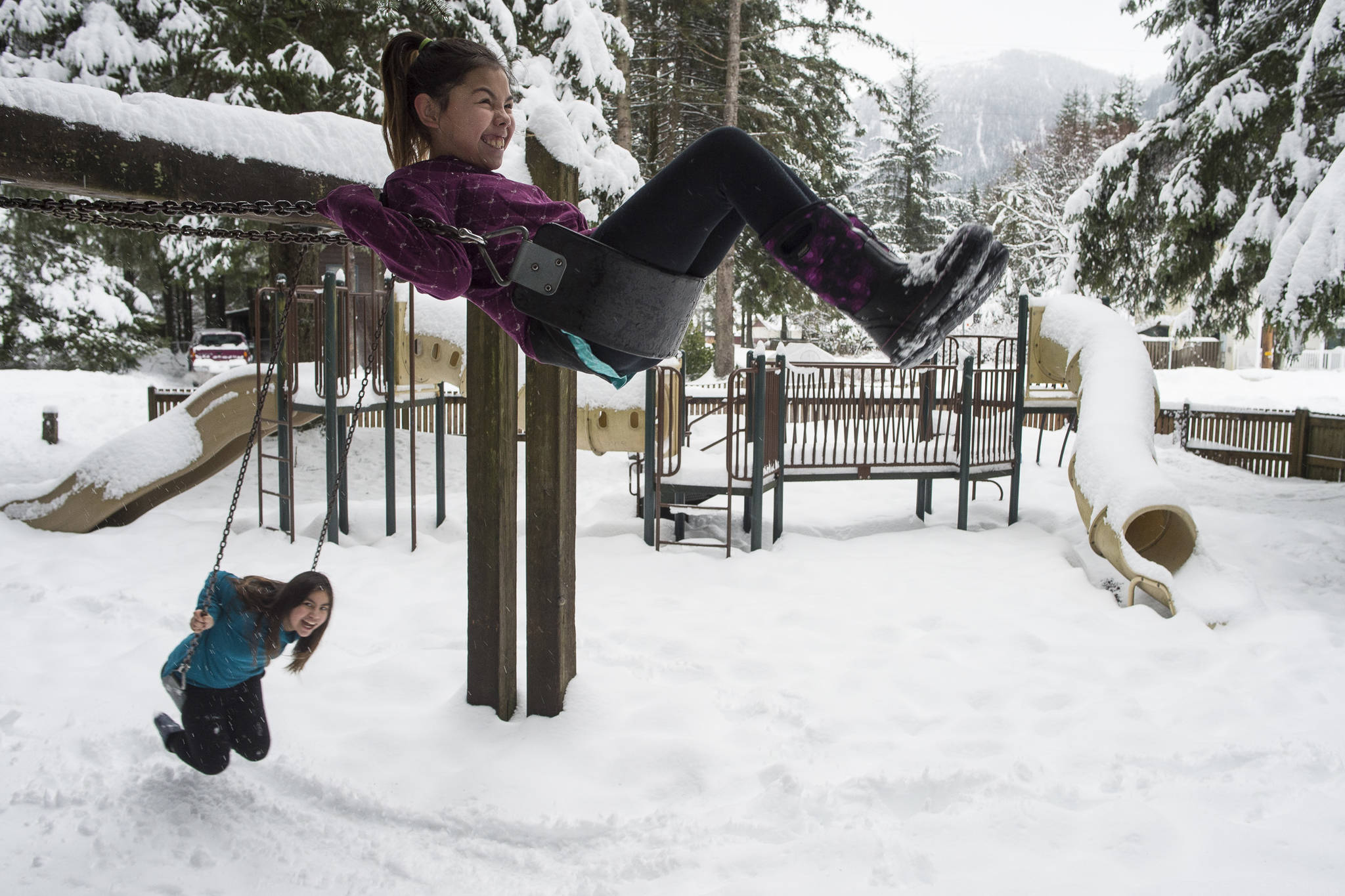 Marci Harriman, 11, top, and Lauryn Dybdahl, 10, makes use of the swings at the Sigoowu Ye Park (Fun Place) in Lemon Creek on Monday, Jan. 21, 2019. The City and Borough of Juneau has updated its Parks & Recreation Master Plan with Lemon Creek referred to as a park desert.