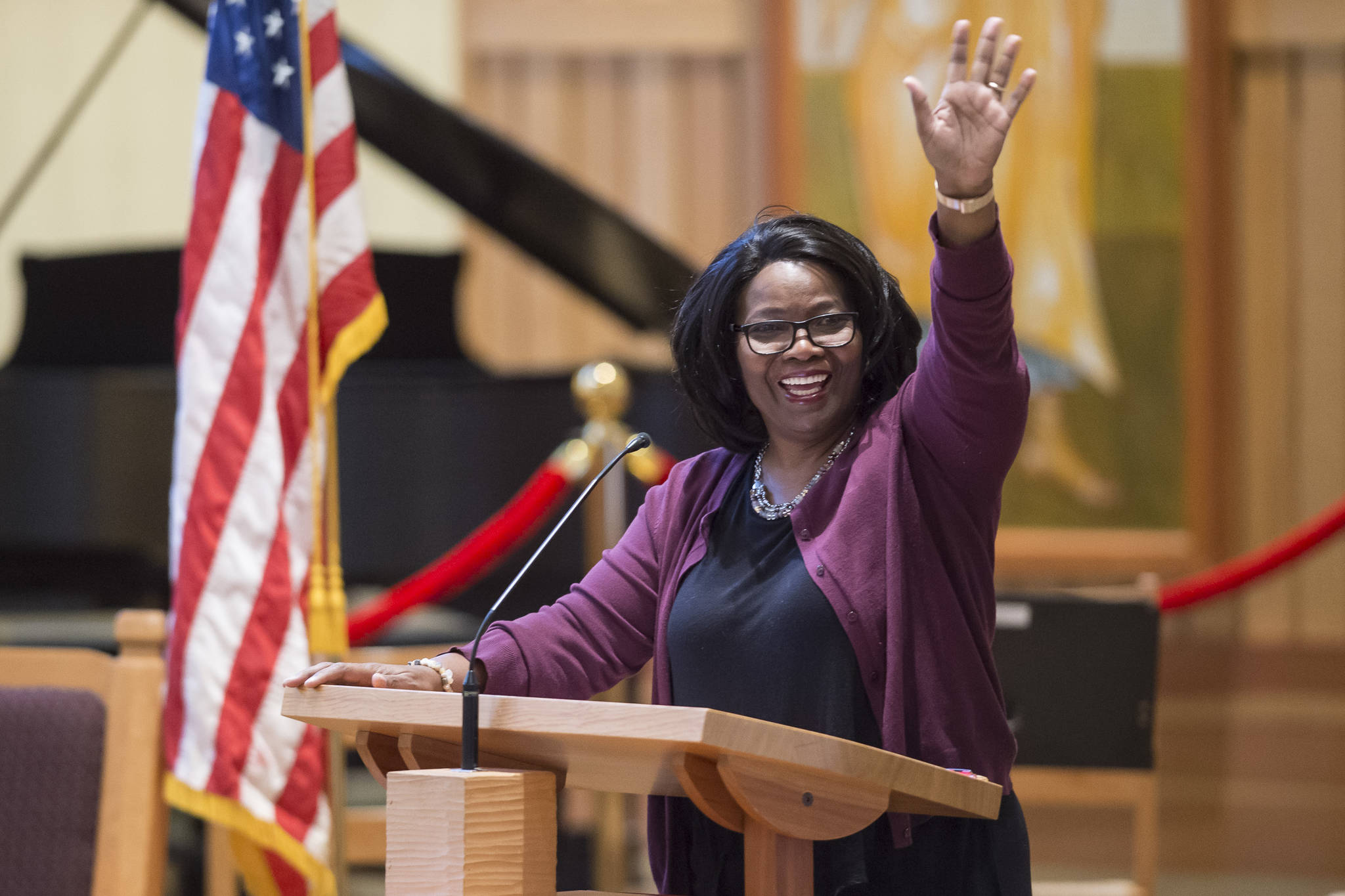 Speaker Michelle Monts, a former president of the Black Awareness Association, waves to her grandchildren in the audience at the Dr. Martin Luther King Jr. 2019 Community Celebration at St. Paul’s Catholic Church on Monday, Jan. 21, 2019. (Michael Penn | Juneau Empire)