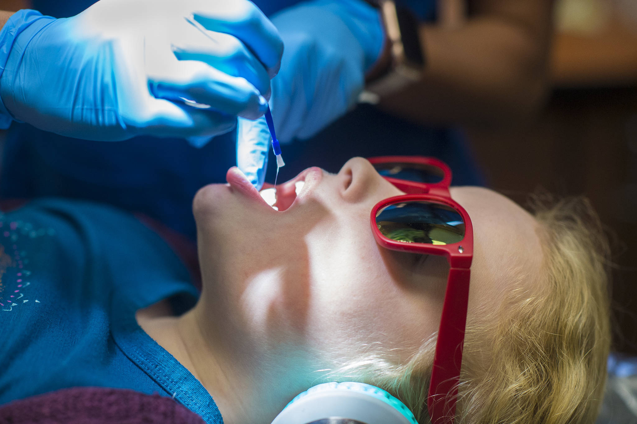 Tynly Booth, 8, holds still as Dr. Jessica Branco, of Juneau Pediatric Dentistry, applies a topical flouride varnish during a checkup on Monday, Jan. 14, 2019. (Michael Penn | Juneau Empire)