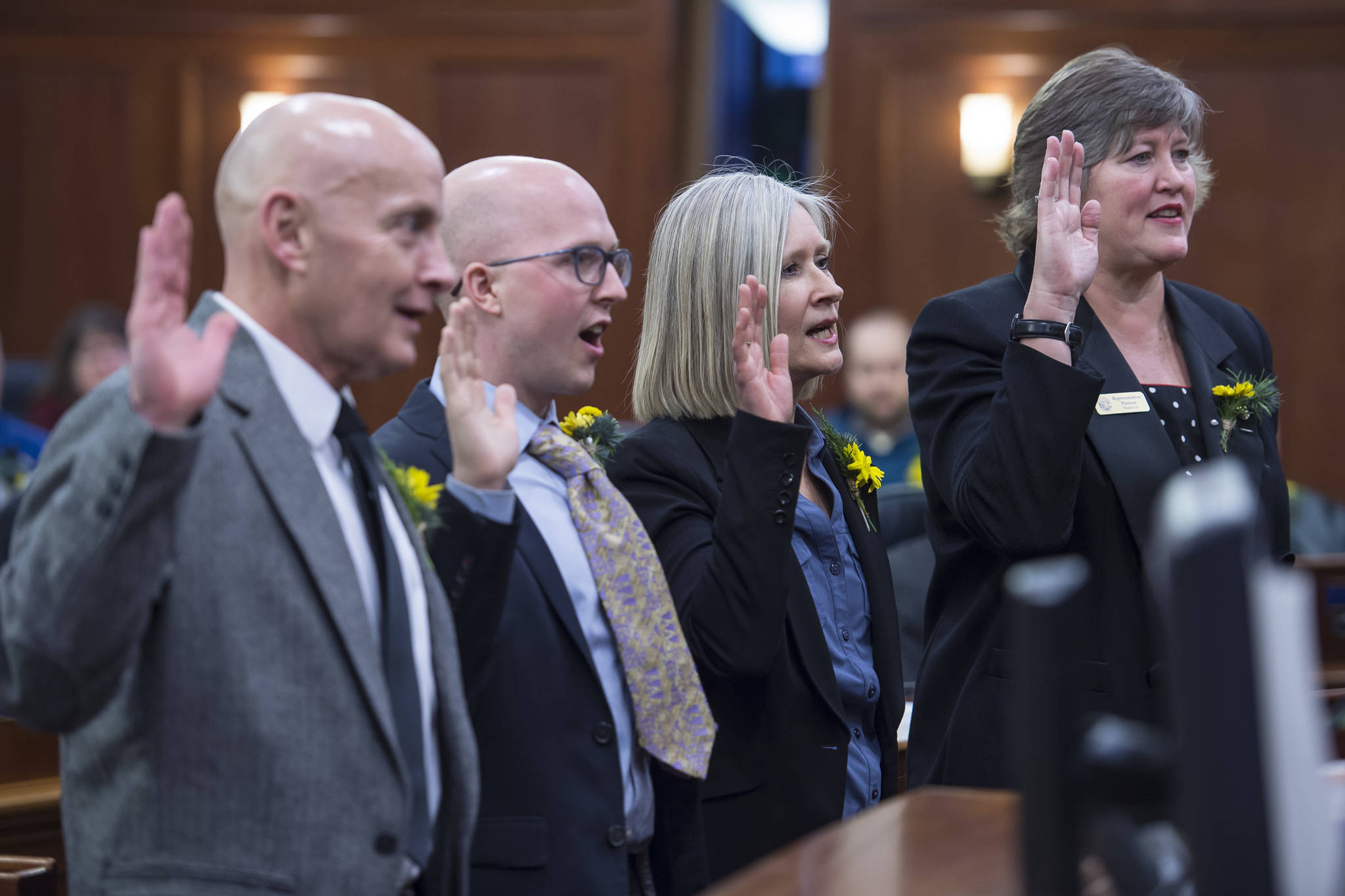 Rep. Dan Ortiz, I-Ketchikan, left, Rep. Jonathan Kreiss-Tomkins, D-Sitka, Rep. Andi Story, D-Juneau, and Rep. Sara Hannan, D-Juneau, take the oath of office on the opening day of the 31st Session of the Alaska Legislature on Tuesday, Jan. 15, 2019. (Michael Penn | Juneau Empire)