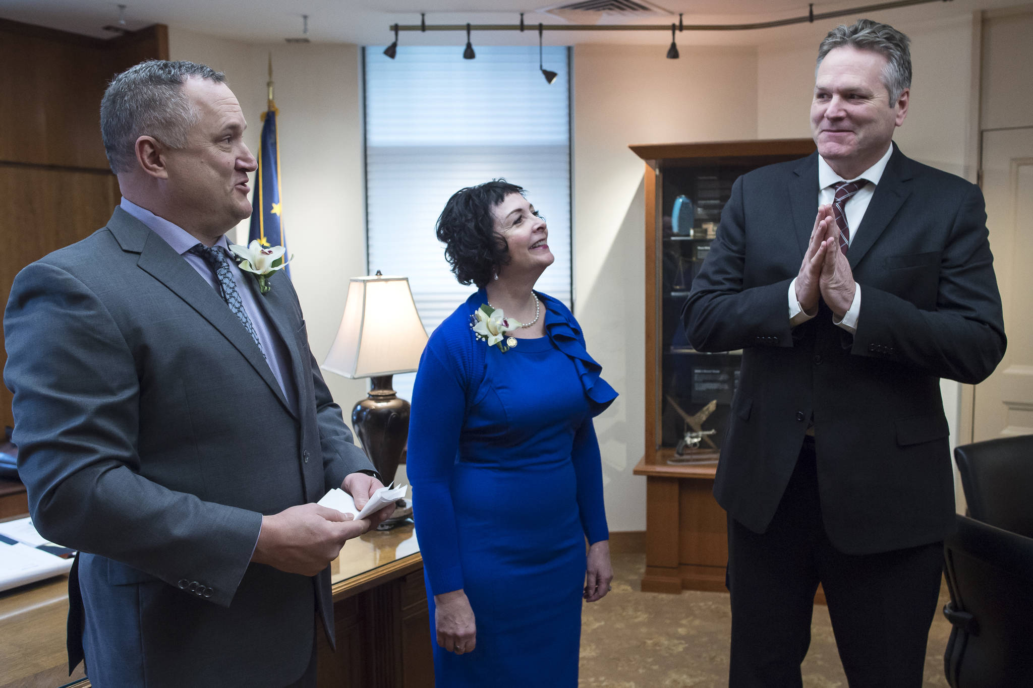 Sen. Mike Shower, R-Wasilla, left, and Sen. Shelley Hughes, R-Palmer, relay a message to Gov. Michael J. Dunleavy in his Capitol office that the Senate is open and ready for business on the first day of the 31st Session of the Alaska Legislature on Tuesday, Jan. 15, 2019. (Michael Penn | Juneau Empire)