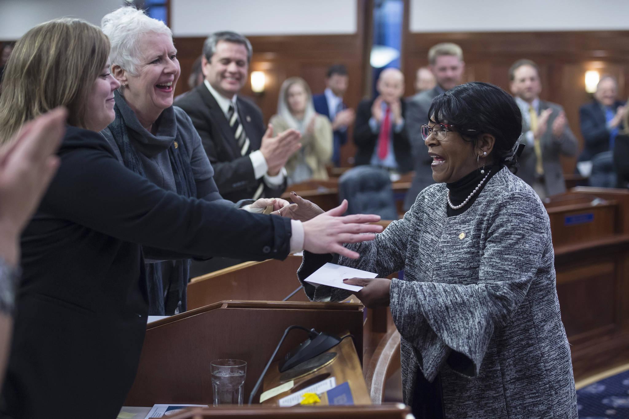 Rep. Sharon Jackson, R-Eagle River, right, is congratulated by House members after being sworn into the House District 13 seat on Thursday, Jan. 17, 2019. (Michael Penn | Juneau Empire)