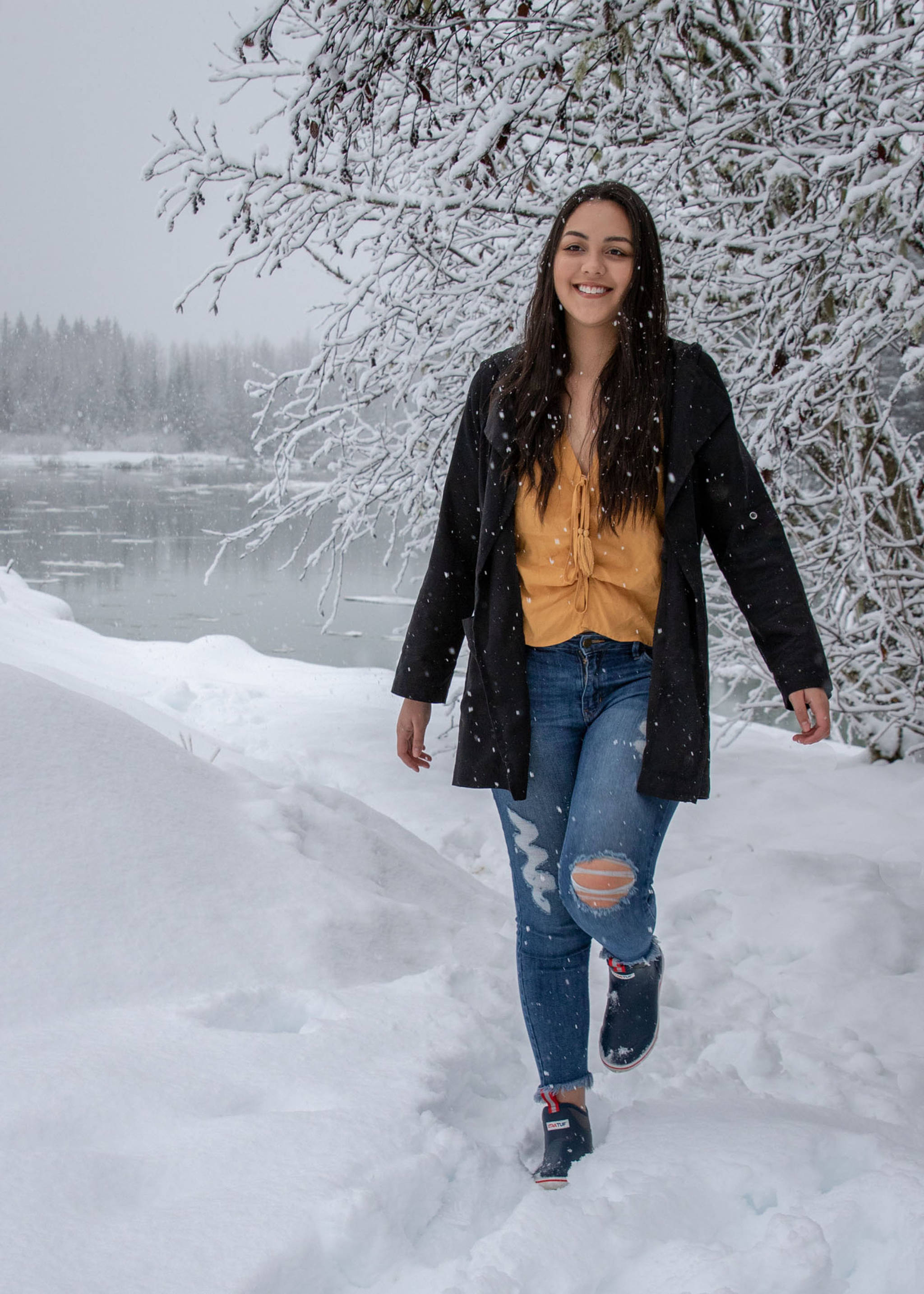 Jan. 27, 2019: On a snowy morning near the Mendenhall River, Taylor Baker was a definite bright spot. Her gold blouse from H&M, distressed jeans from Apricot Lane and black trench coat from Be Cool LA really stood out against the otherwise white landscape. I also loved the navy low-cut Xtratufs that she borrowed from her boyfriend Andy — practical and attractive!