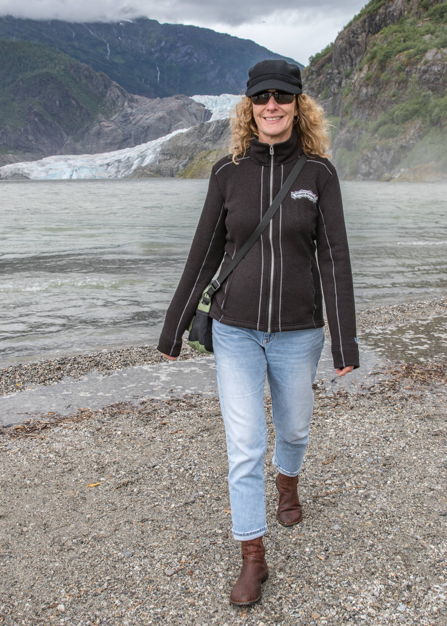 Oct. 7, 2018: On this cool day by the glacier, Veronica Sullivan from Chico, California, stayed warm in style. She pairs a wool zip-up jacket from Kuhl and cuff-rolled Gap jeans with brown leather boots from Merrell. Her black wool busker cap, Chico sling purse and Rayban sunglasses complete her practical but trendy look.