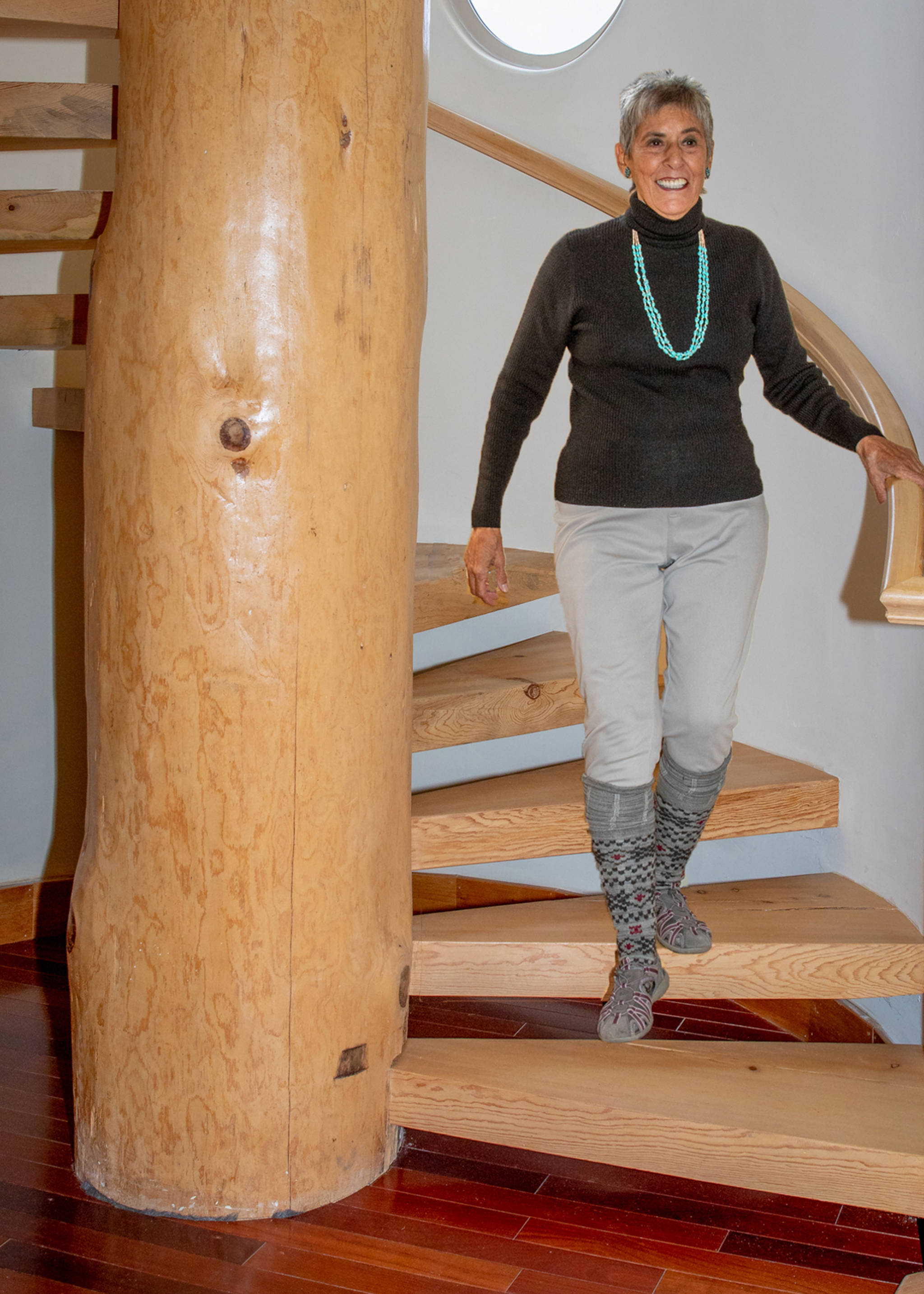 Nov. 11, 2018: Even if it is dreary and gray outside, autumn fashion can still shine indoors. Linda Dahl is a perfect example. She combines fitted jean style leggings with a cozy black wool sweater from Charter Club. Her accessories include colorful knee socks, Croft & Barrow sandals, a vibrant turquoise necklace and earrings from Arizona, and her ever-present smile.