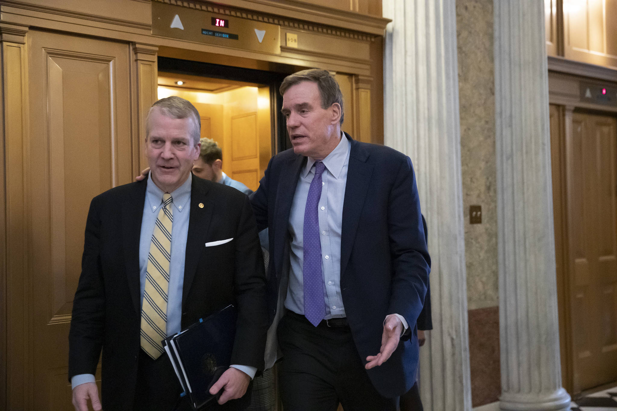 Sen. Dan Sullivan, R-Alaska, left, and Sen. Mark Warner, D-Virginia, the vice-chair of the Senate Intelligence Committee, arrive at the Senate prior to a vote on ending the partial government shutdown, at the Capitol in Washington on Thursday, Jan. 24, 2019. (J. Scott Applewhite | Associated Press)