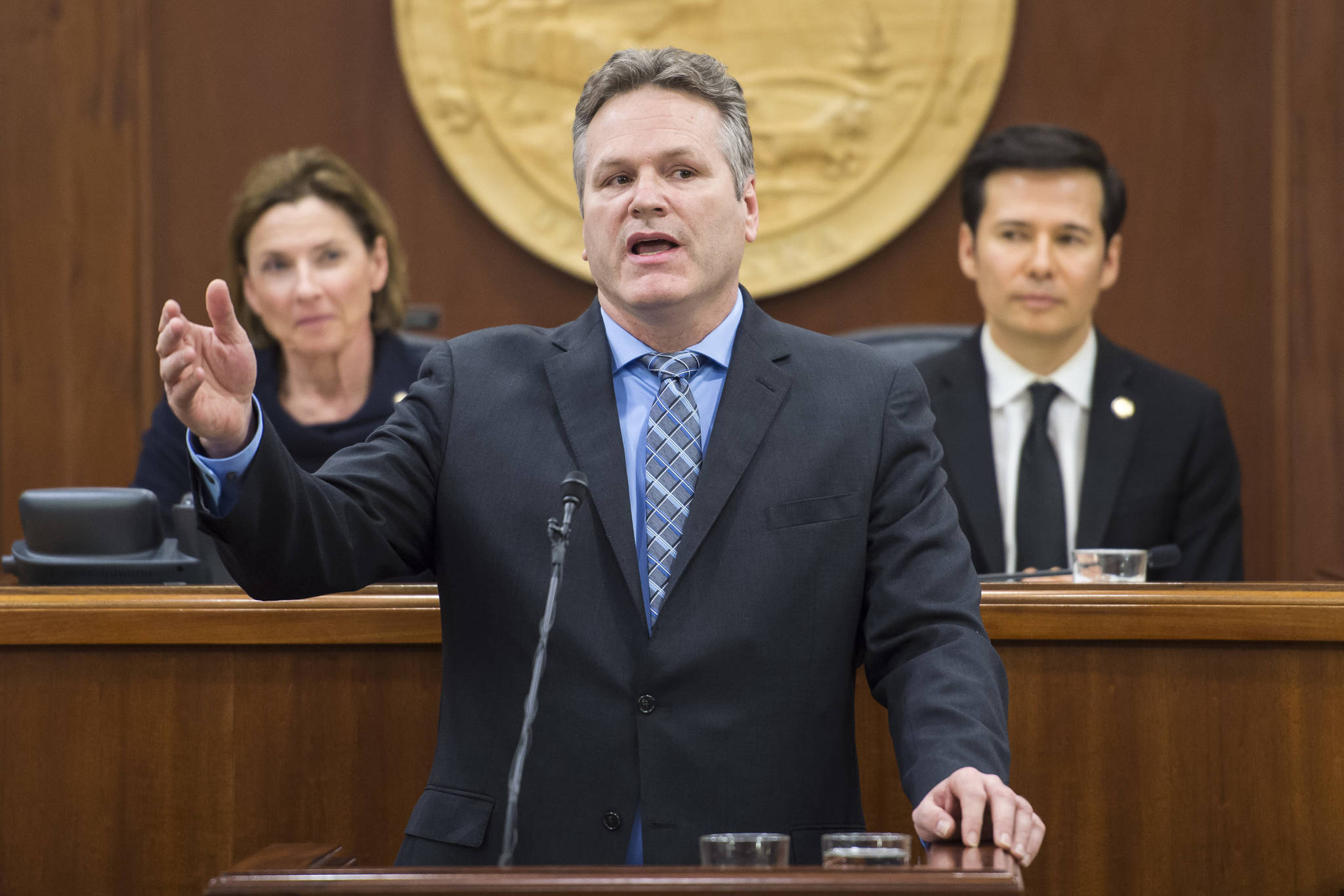 Gov. Mike Dunleavy give his State of the State speech to a Joint Session of the Alaska Legislature as Senate President Cathy Giessel, R-Anchorage, left, and House Speaker Pro Tempore Rep. Neal Foster, D-Nome, listen at the Capitol on Tuesday, Jan. 22, 2019. (Michael Penn | Juneau Empire)